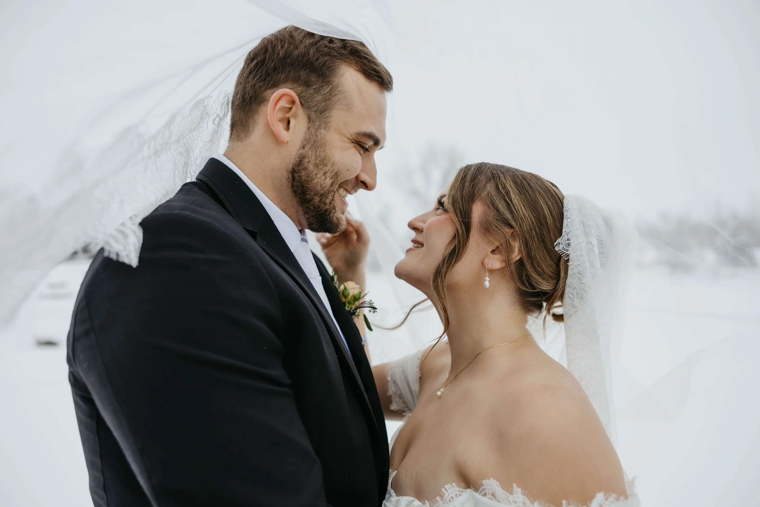 Couple on their wedding day doing couple portraits in the snow at The Atrium in Sioux Falls, South Dakota.