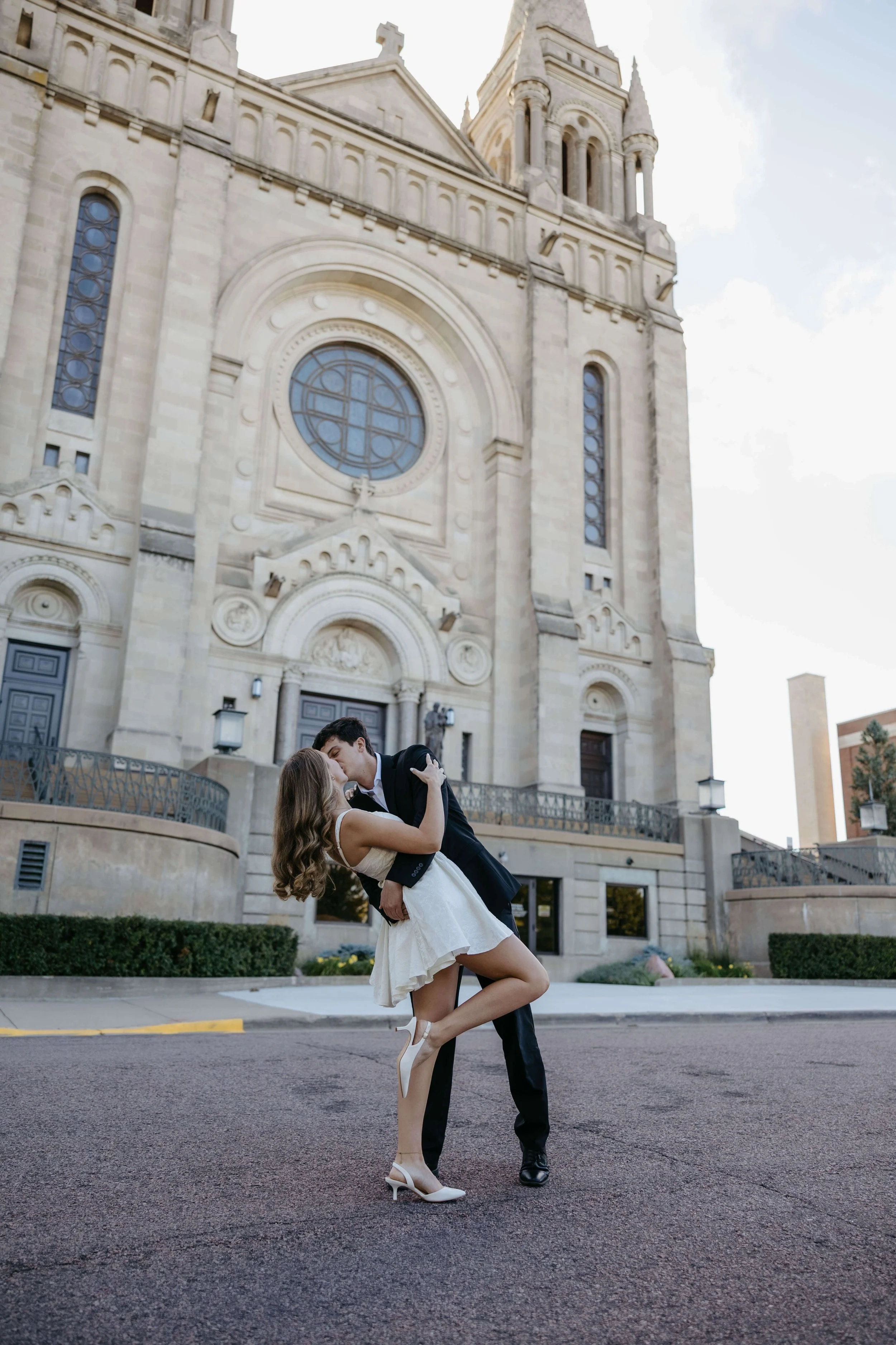 Couple kissing outside St Joesphs Cathedral in Sioux Falls, South Dakota