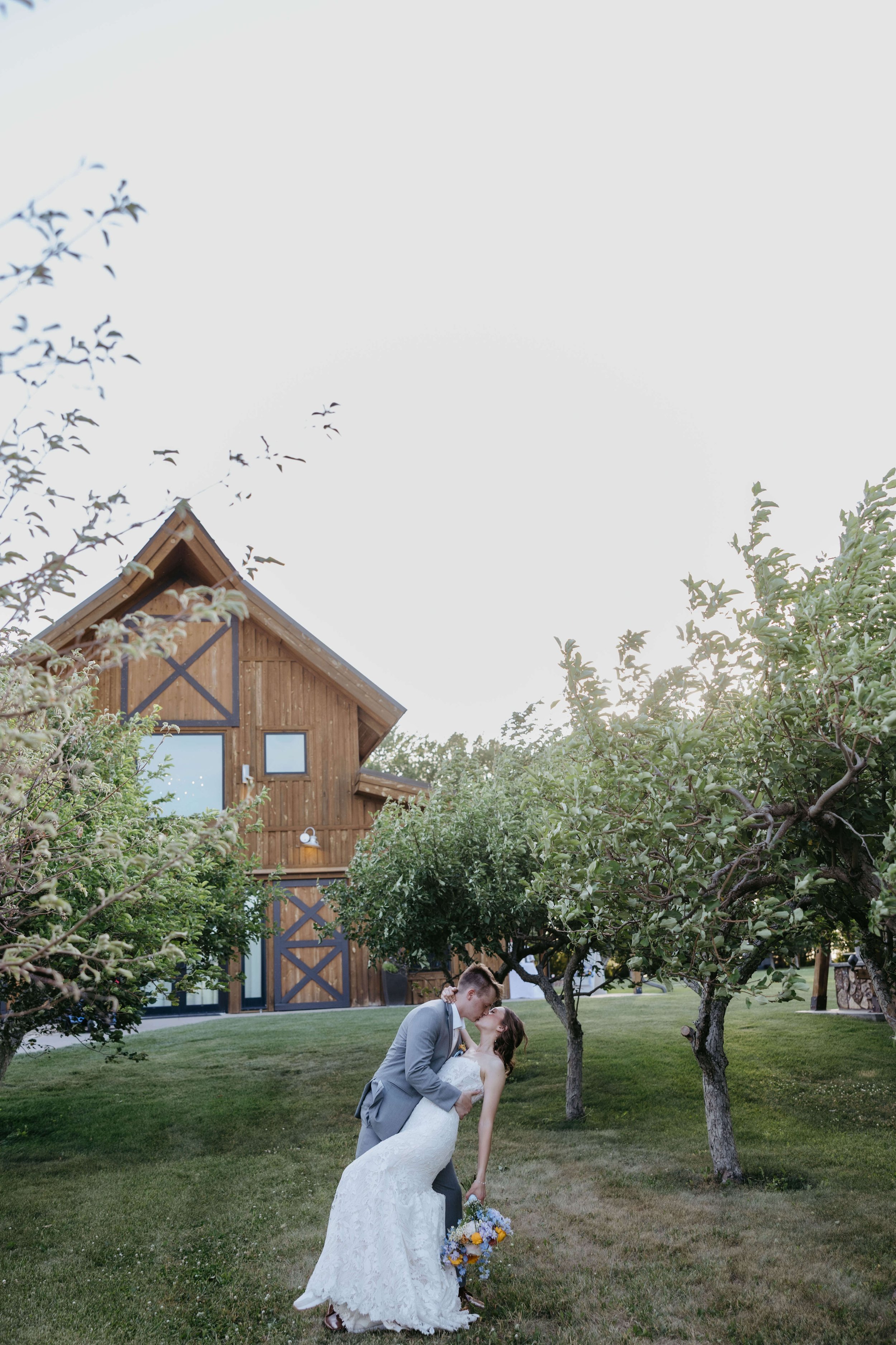 Bride and groom doing dreaming sunset portraits at The Meadow barn in Harrisburg South Dakota, photographed by Jenna Heckel Photography.