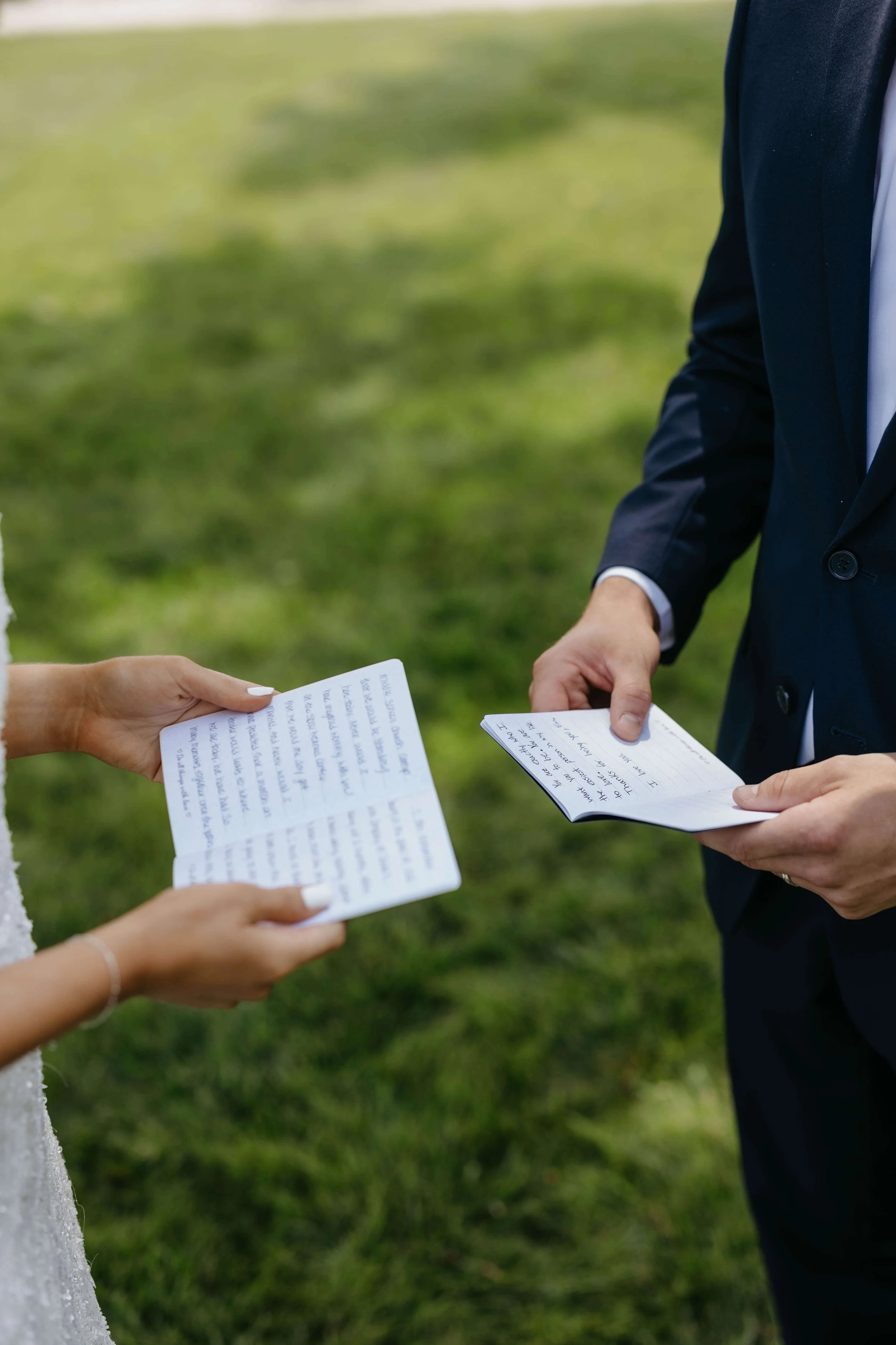 Couple reading vows to each other during first look on their wedding day. Photographed by Jenna Heckel Photography