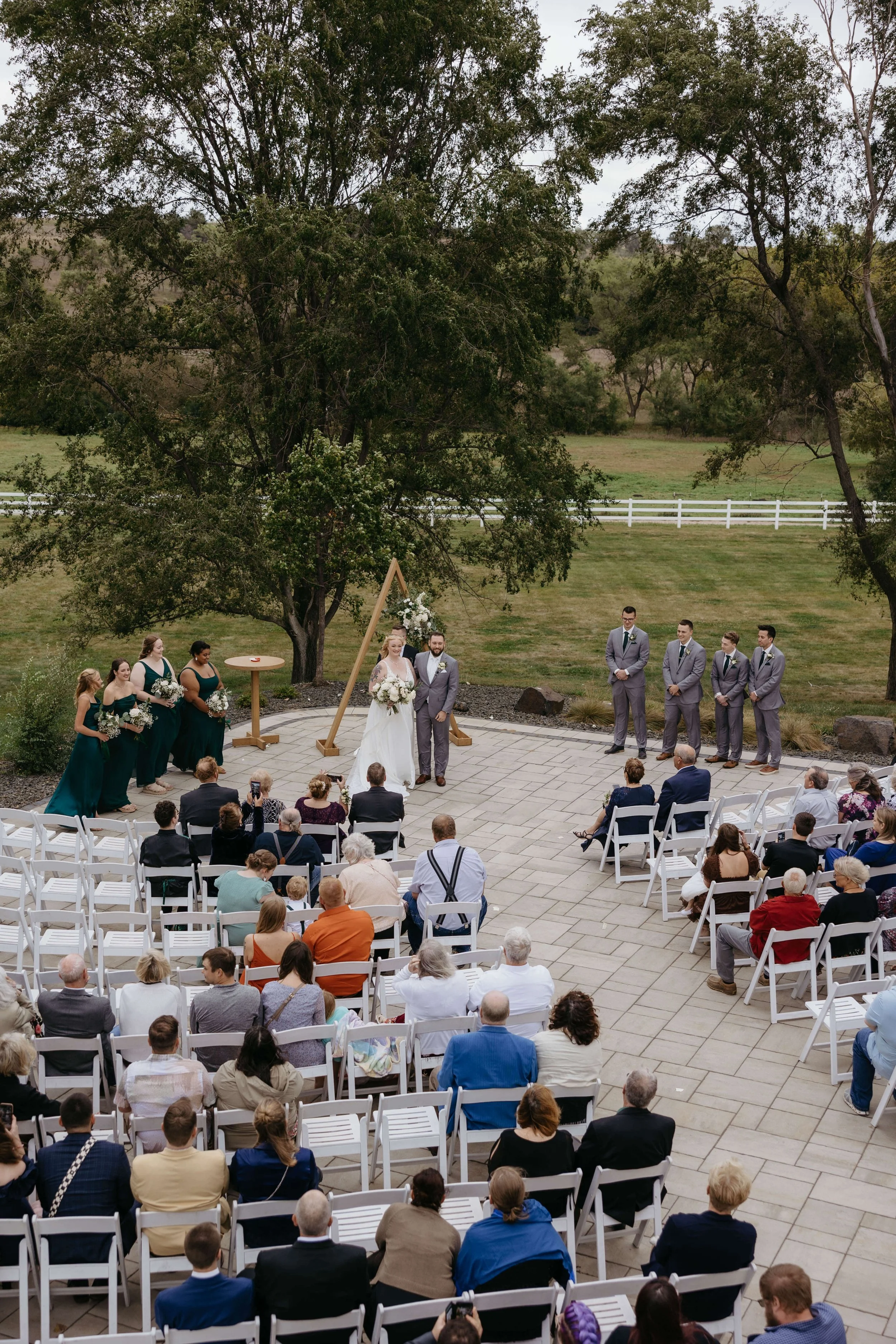 Bride and groom during their ceremony at Laural Ridge Barn in Sioux Falls, South Dakota. Photographed by Jenna Heckel Photography. 
