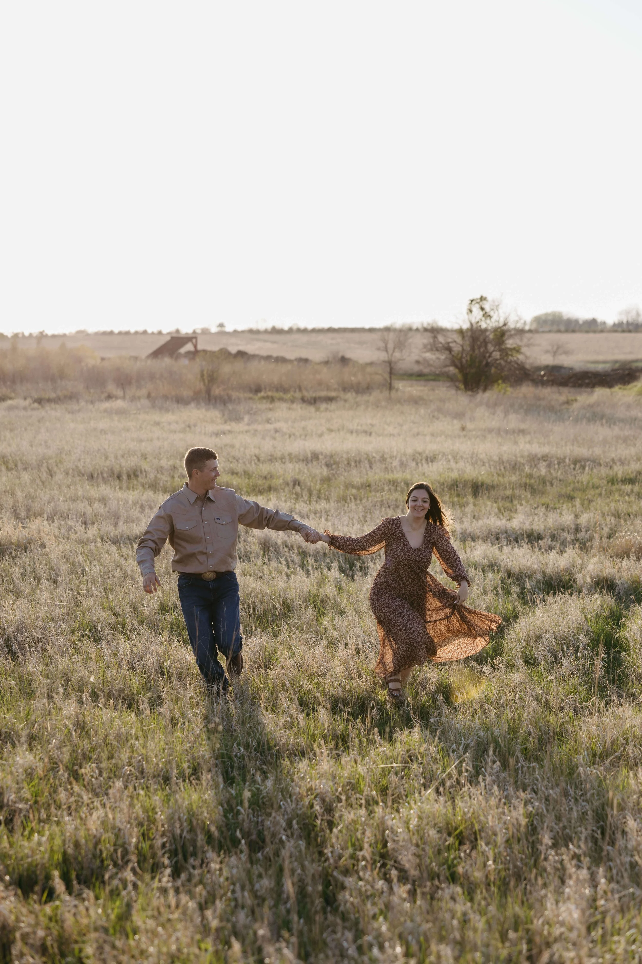 Couple holding hands at their engagement session at Prairie shores Resort in Madison SD, Photographed by Jenna Heckel photography.