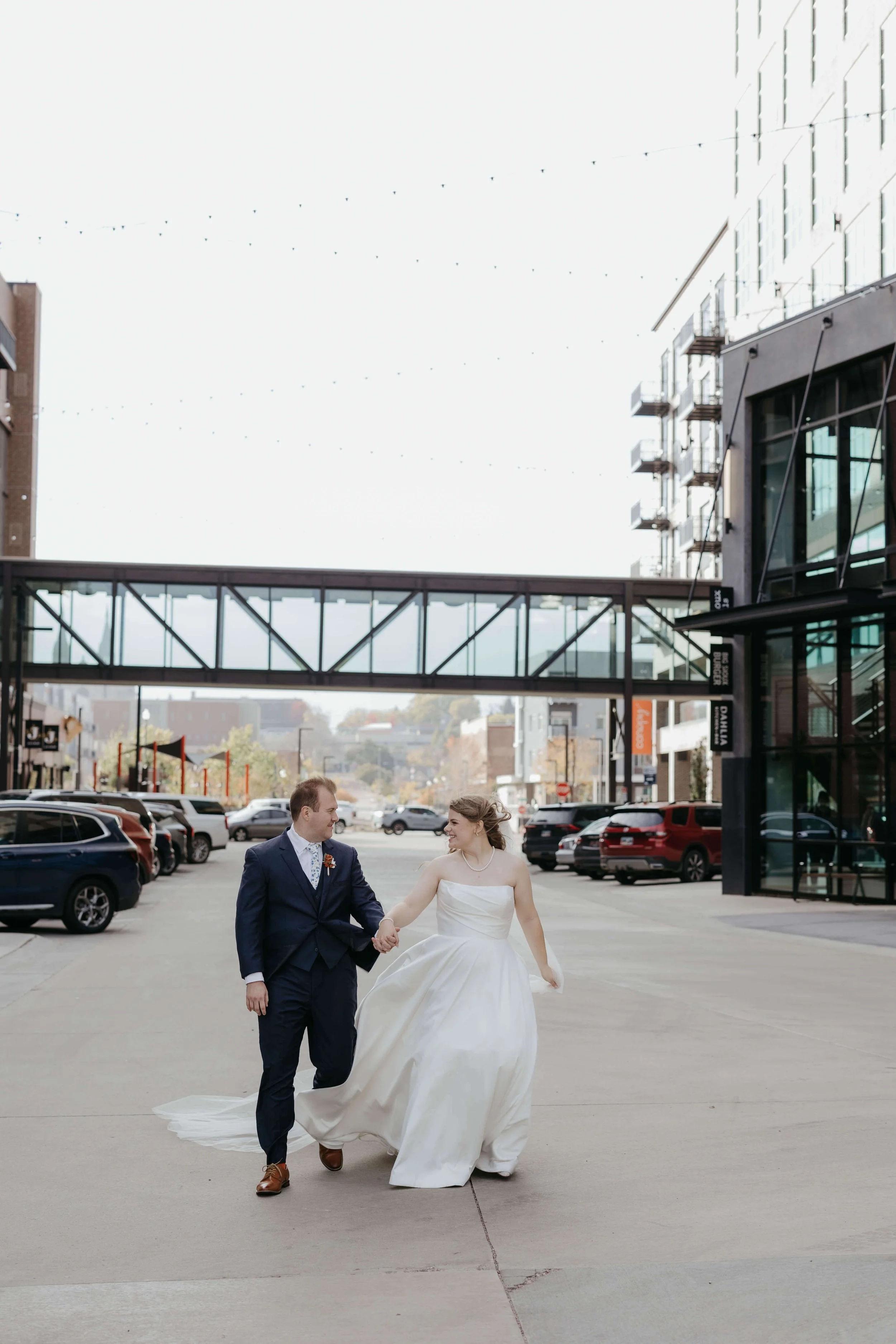 Couple doing portraits outside the Canopy in downtown Sioux Falls. Photographed by Jenna Heckel Photography.