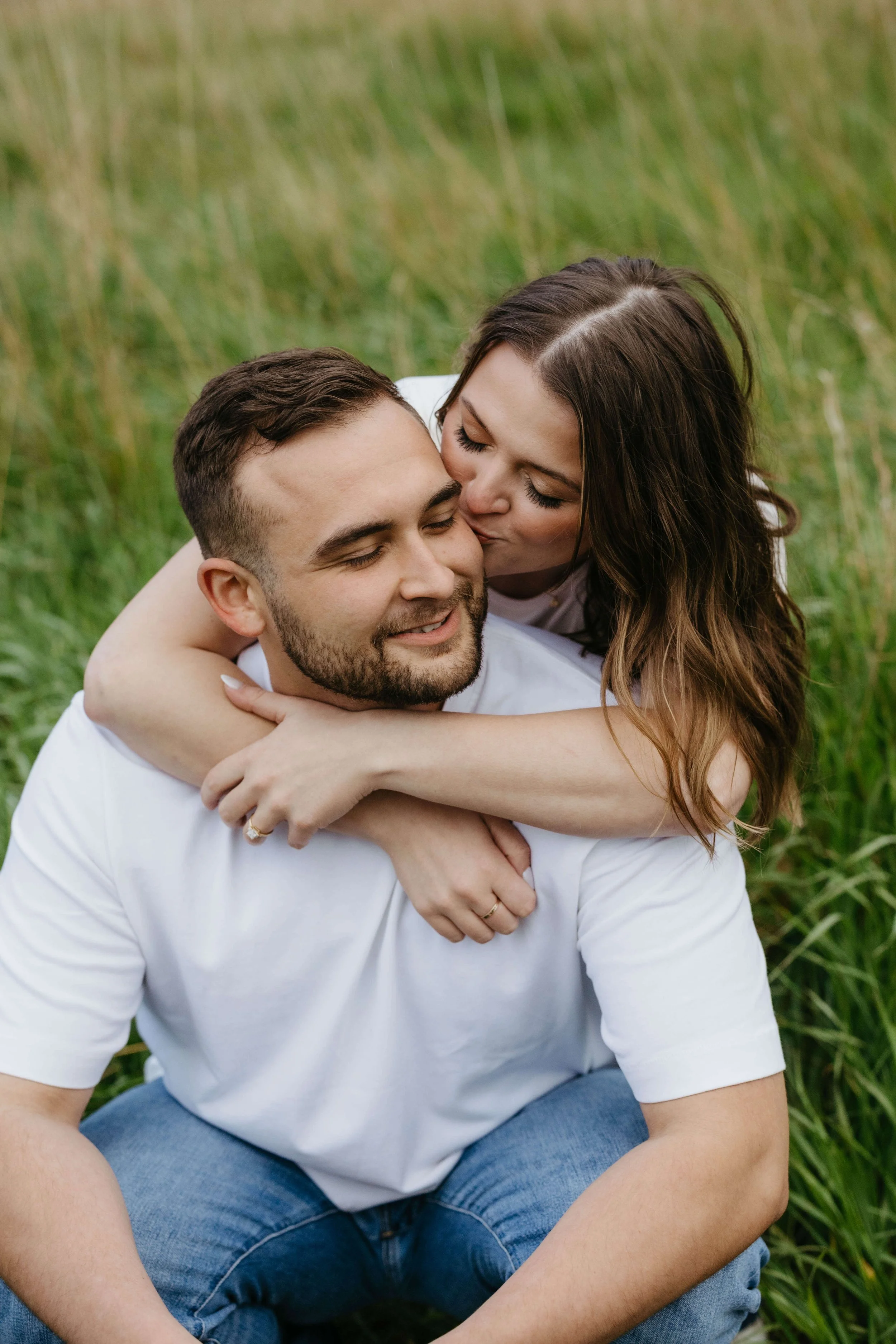 Couple at blue mounds state park during their engagement session in the rain, photographed by Jenna Heckel Photography.