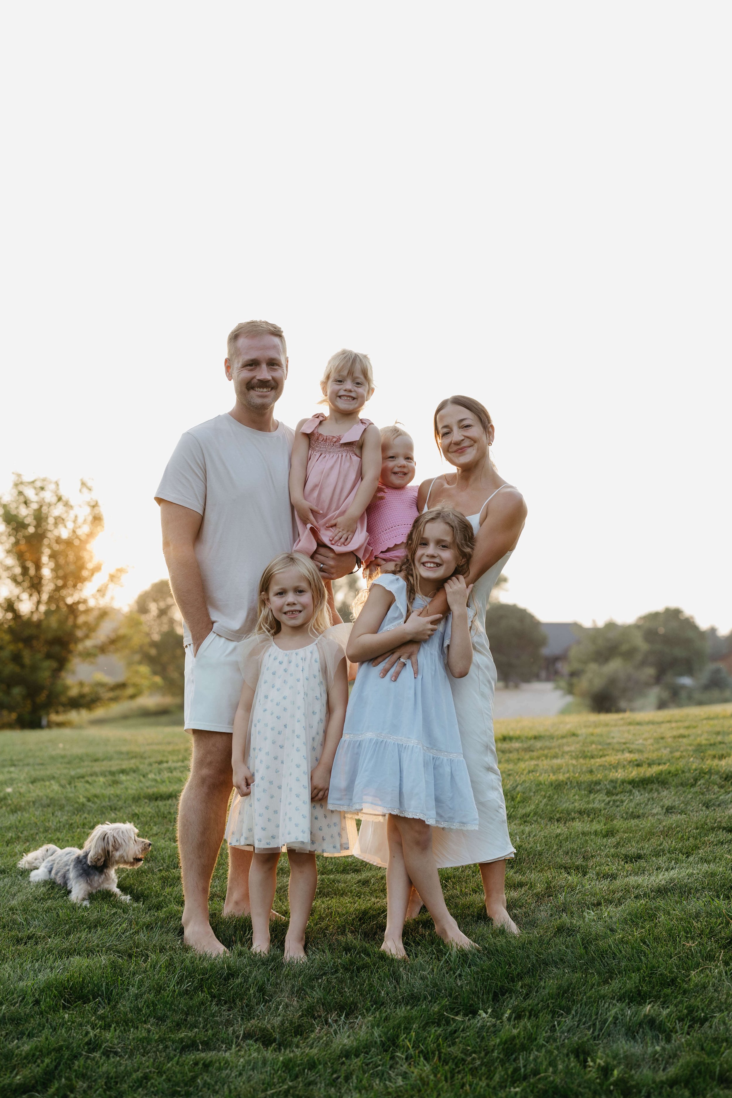 Family session near Brandon South Dakota in the back yard of the family at sunset. Photographed by Jenna Heckel Photography.