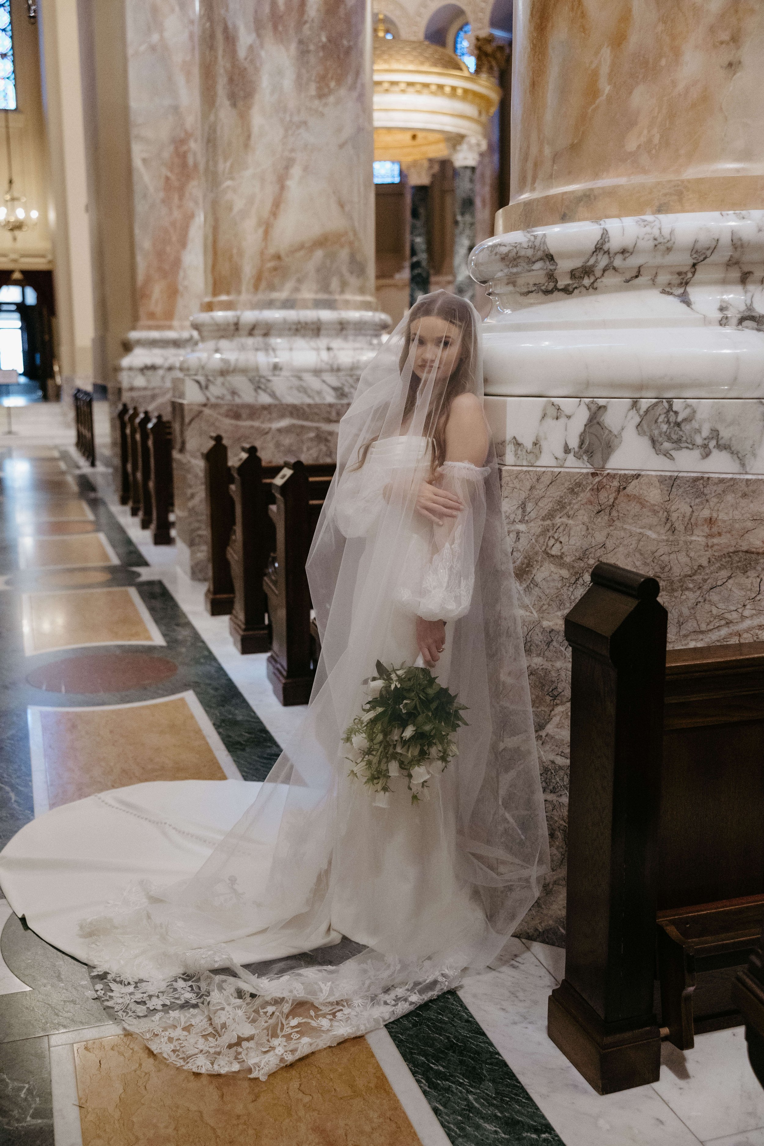 Bride on her wedding day at St. Josephs Cathedral in the historic district of downtown Sioux Falls South Dakota.