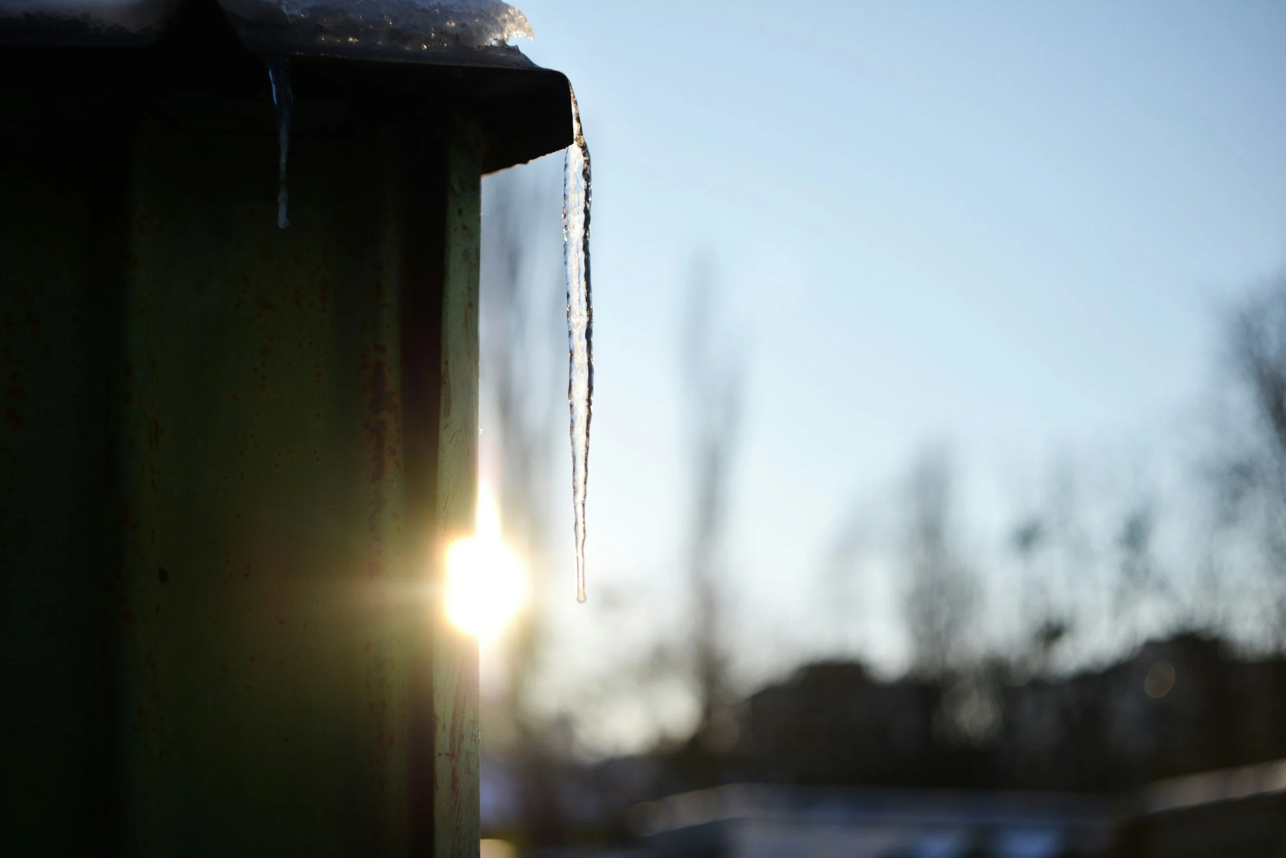 an icicle melting  with the sunset