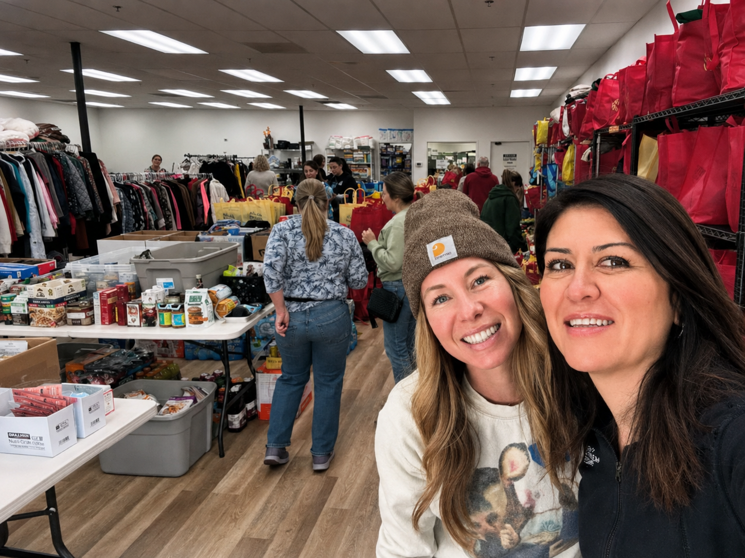 Composed Giving volunteers sorting clothing, food, and essential items for Los Angeles families affected by the 2025 wildfires.
