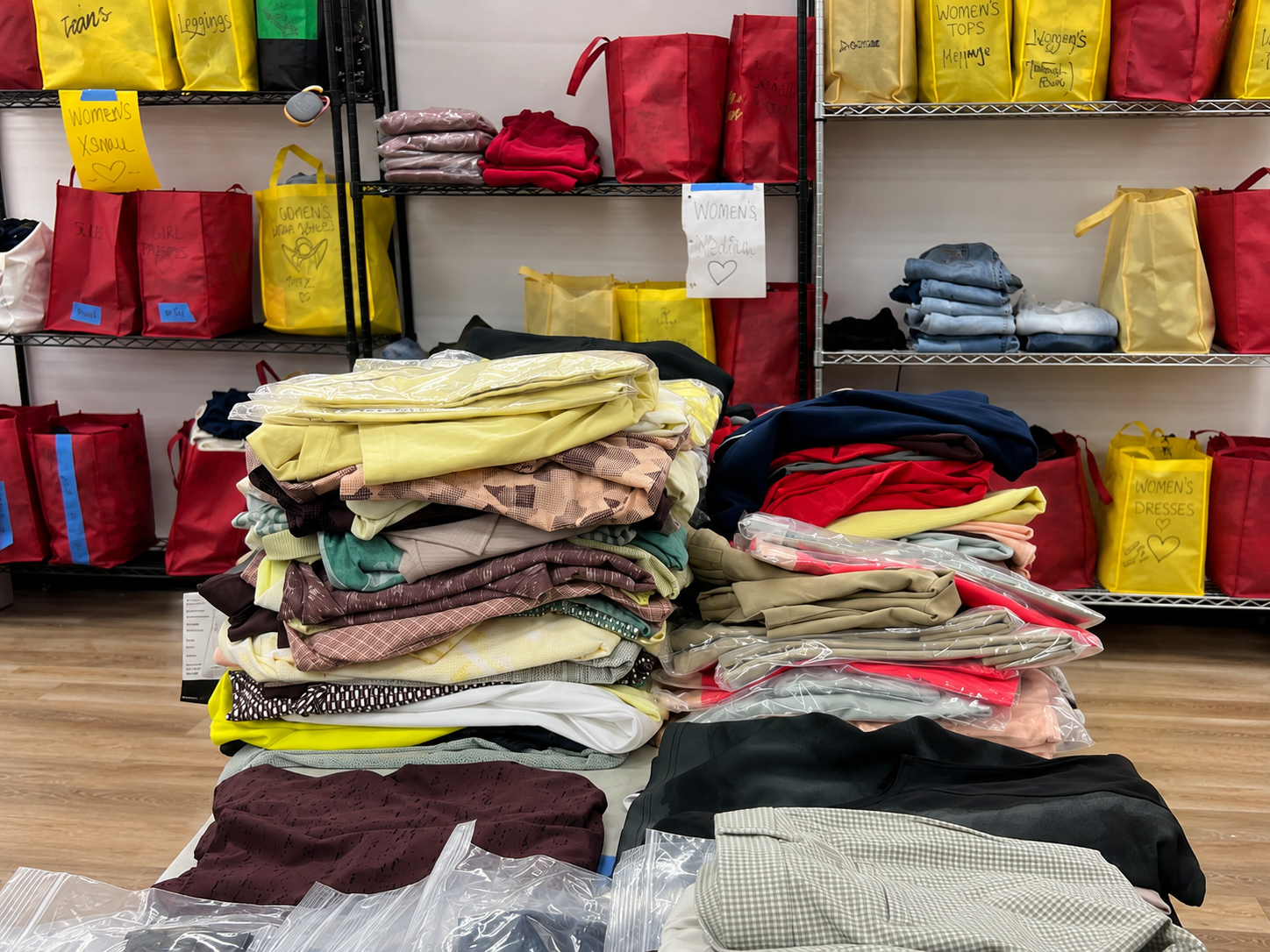 Organized clothing and labeled donation bags being prepared for wildfire-affected families.