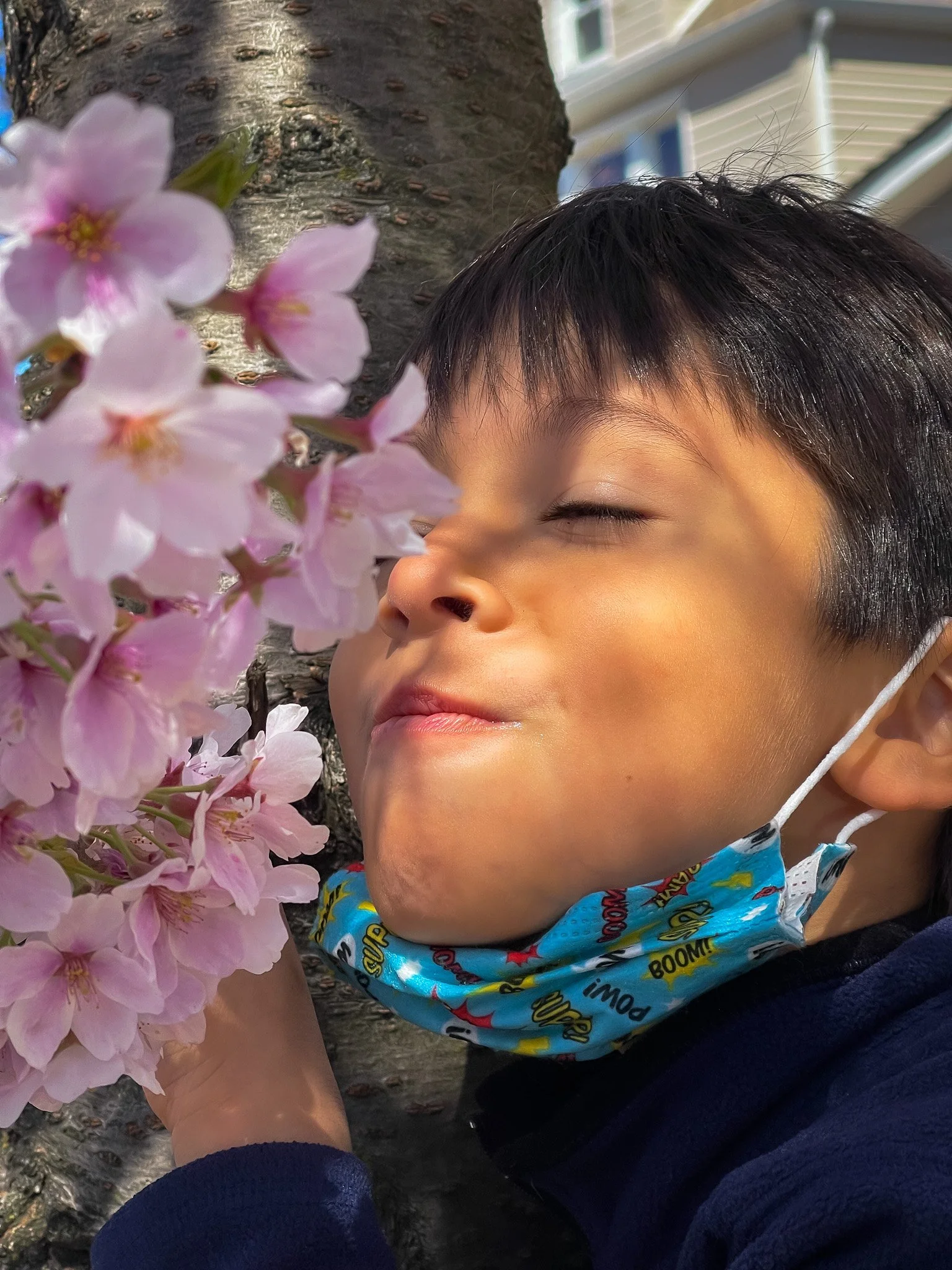 Ethan_sniffs_blossoms_2022.jpg