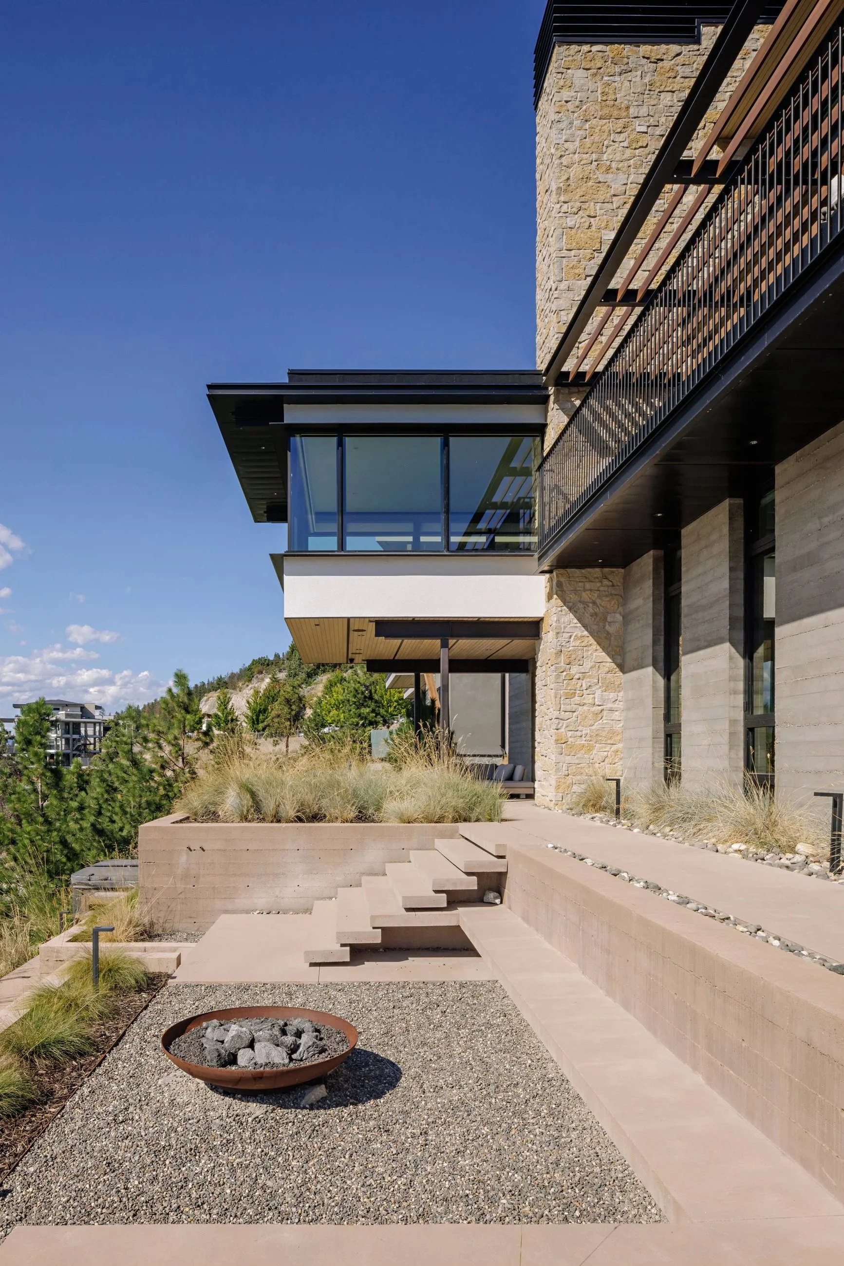 Contemporary lakeside residence in British Columbia, featuring a high cantilevered living space overlooking the lake.