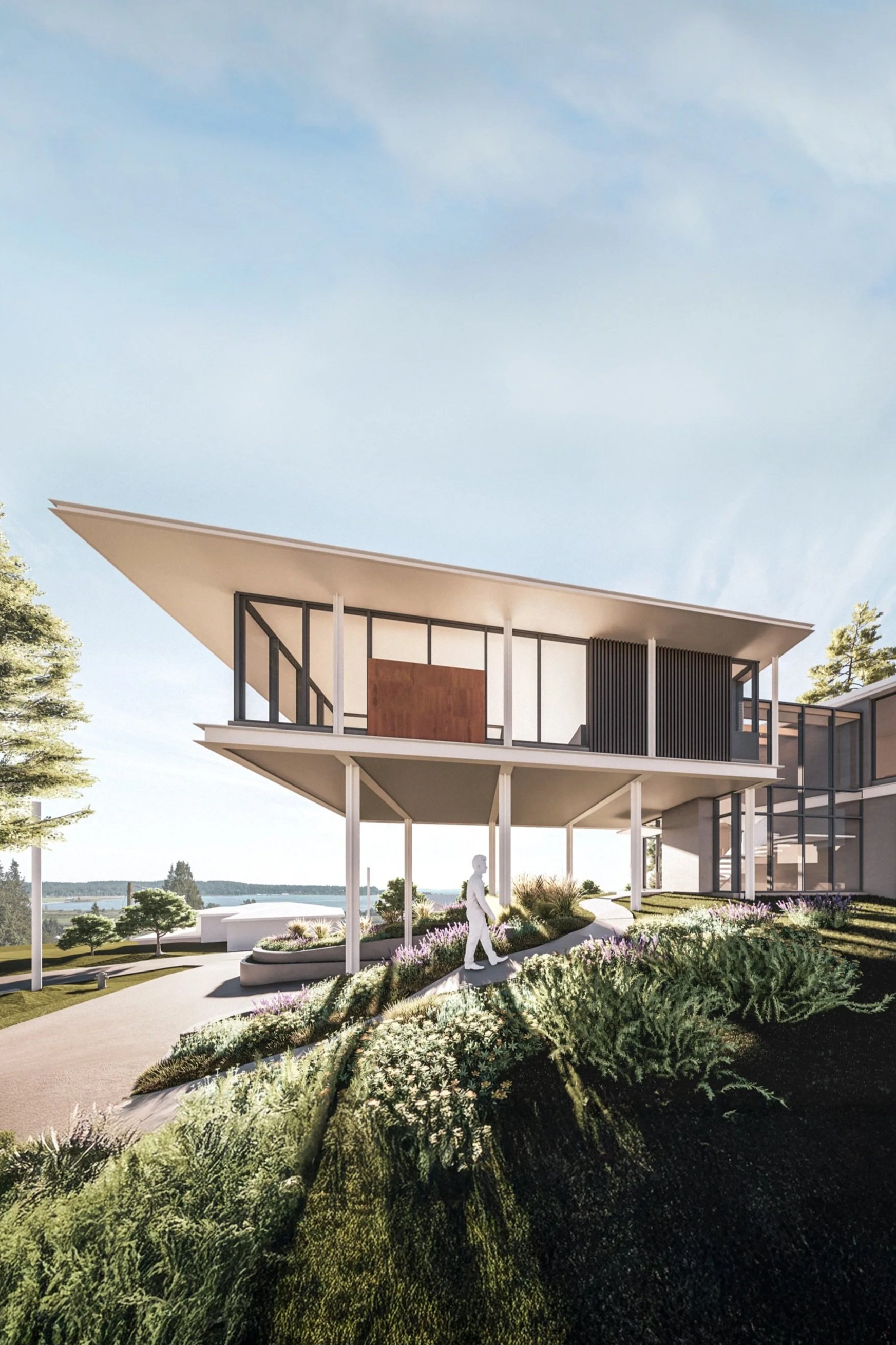Modern two-story house with large glass windows, white and wood exterior, elevated on stilts, surrounded by landscaped garden with shrubs and trees, under a partly cloudy sky.