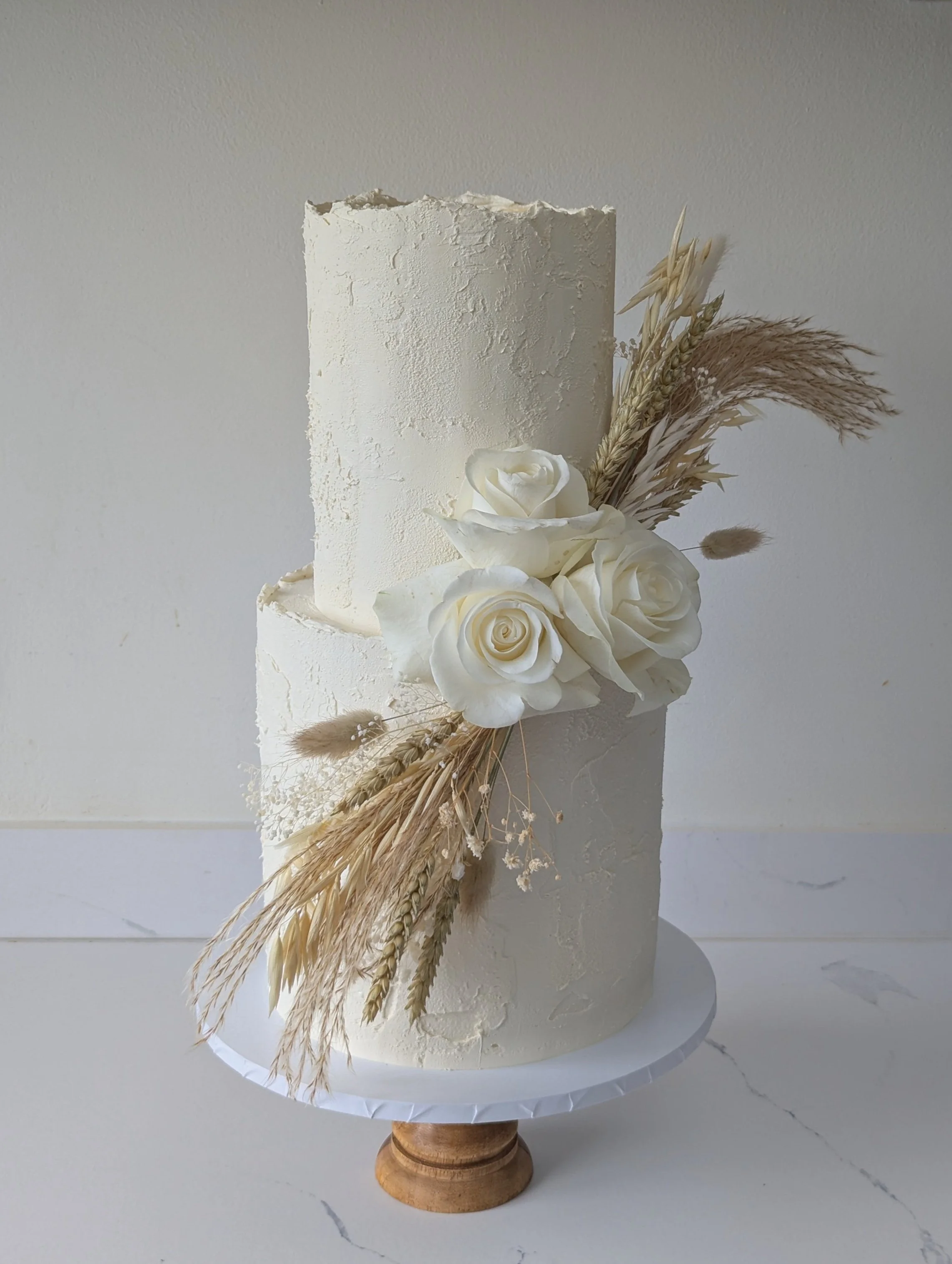 Rustic wedding cake with dried flowers, Bowerchalke Barn, Wiltshire