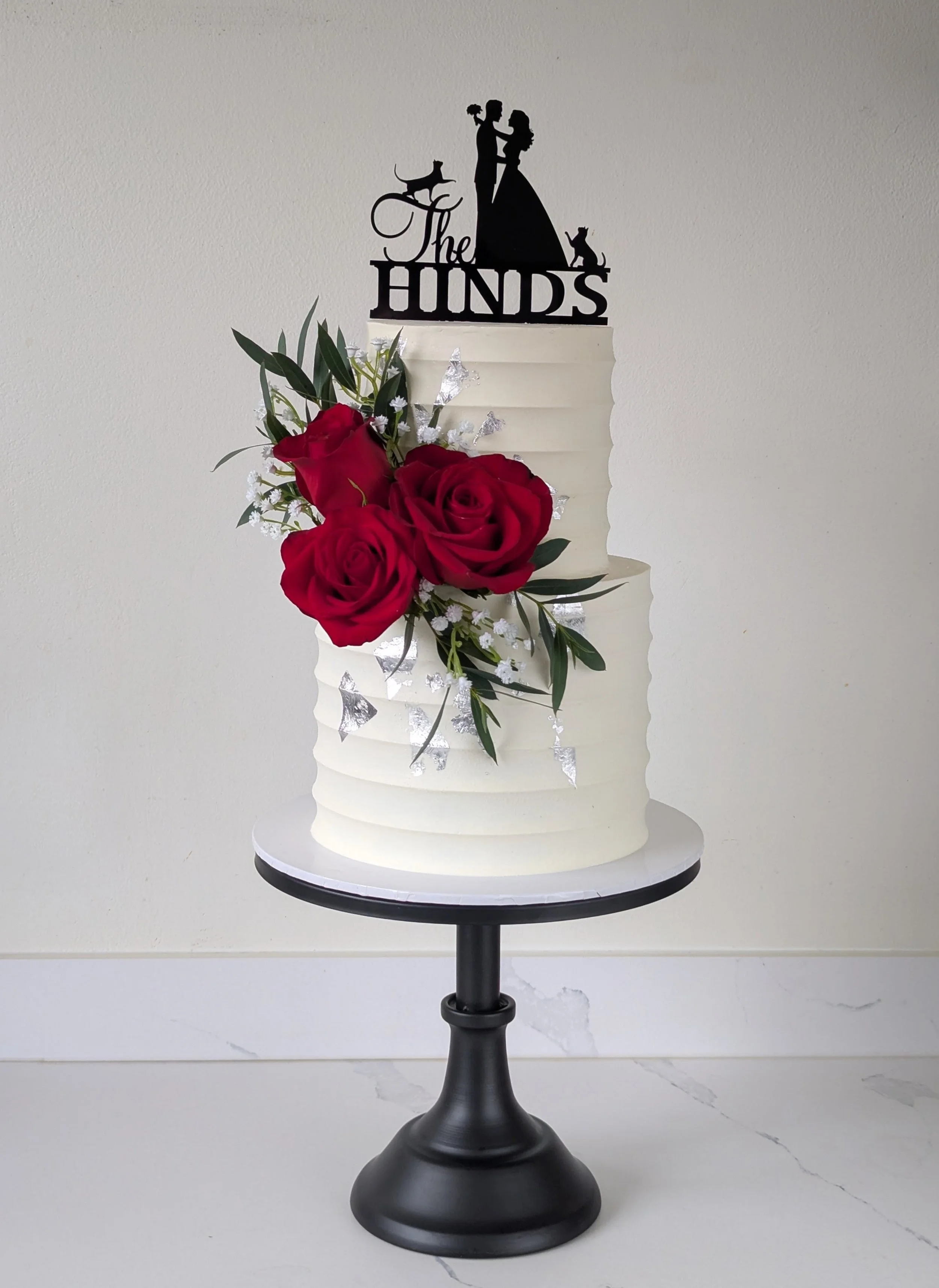 Bowood hotel wedding cake with fresh flowers and cats