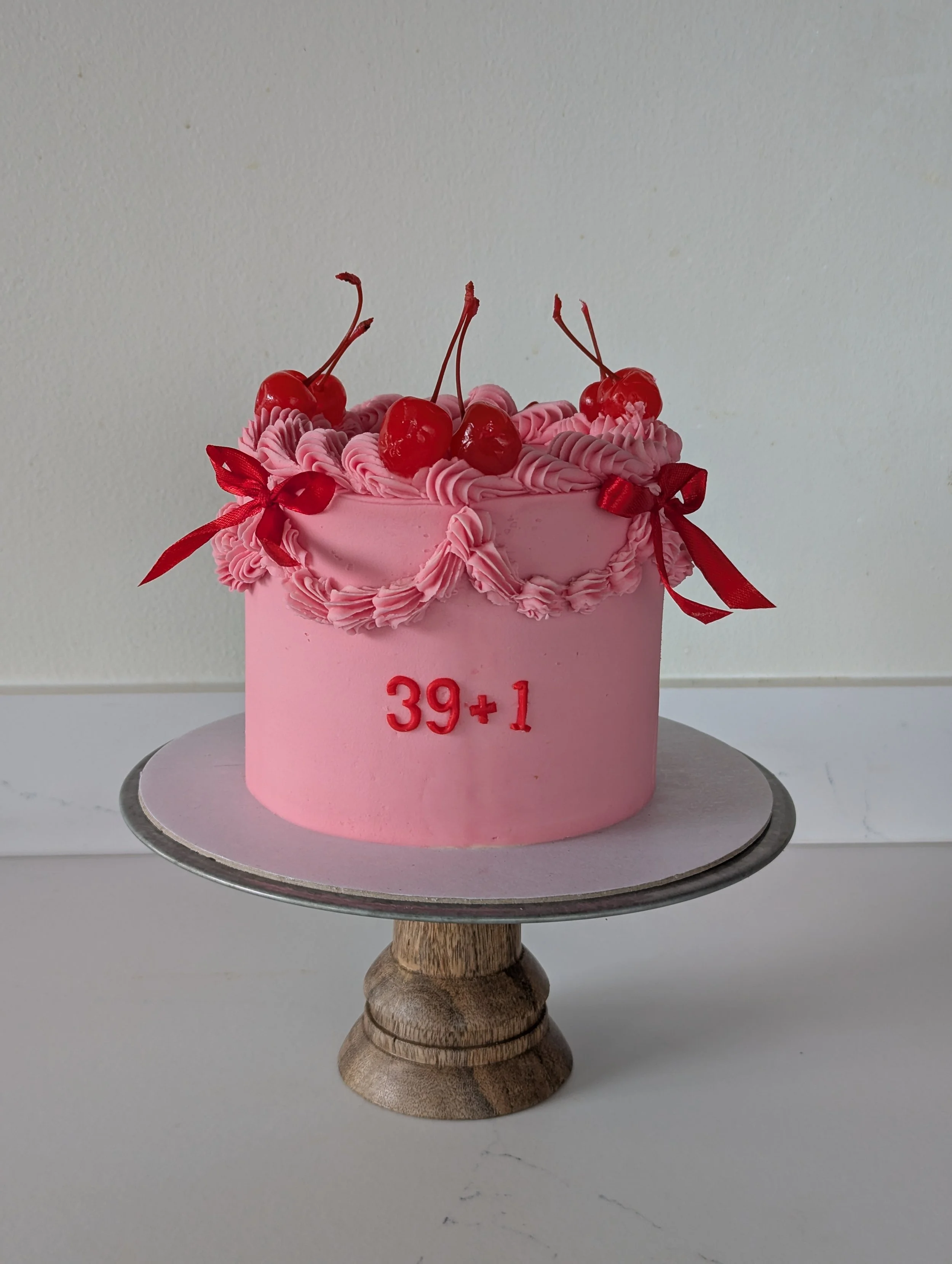 Vintage birthday cake with cherries and bows, wiltshire