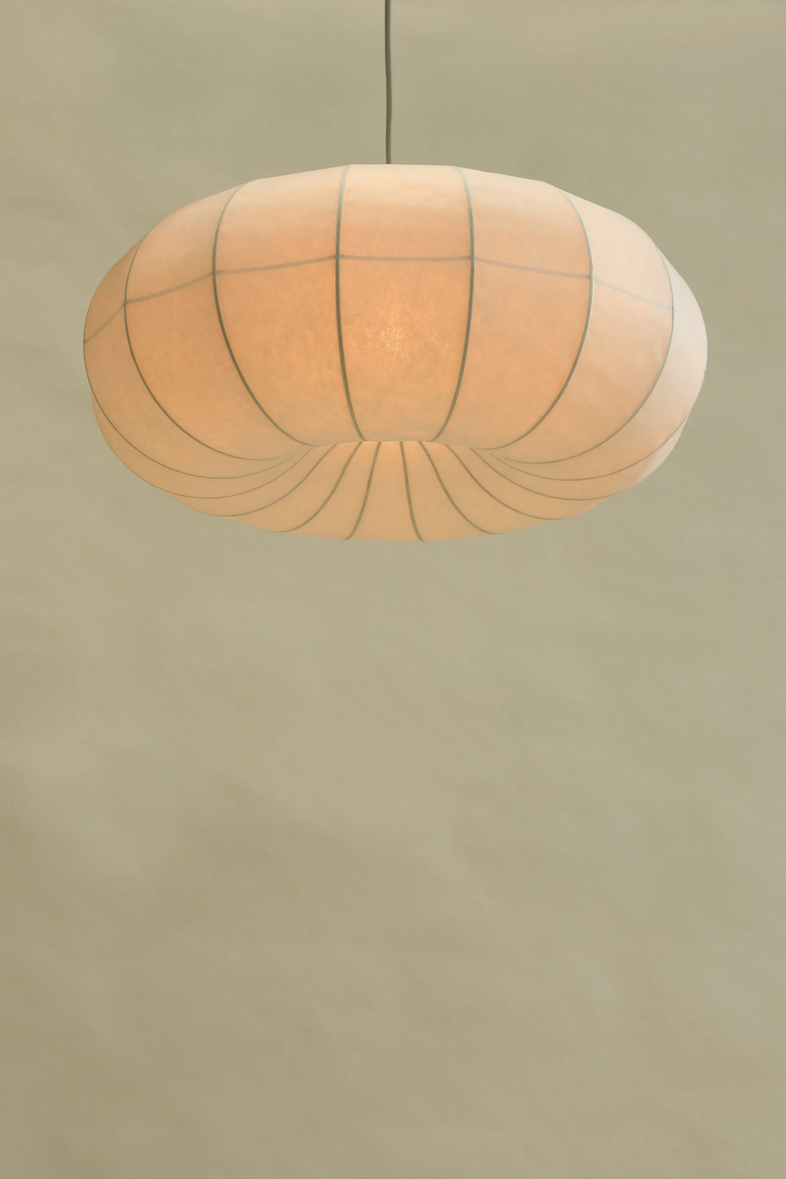 Plumus Pendant Light by Claud Christian – a sculptural paper pendant with curvaceous convex and concave curves, designed as a statement lighting feature for contemporary, minimalist, and design-led interiors.