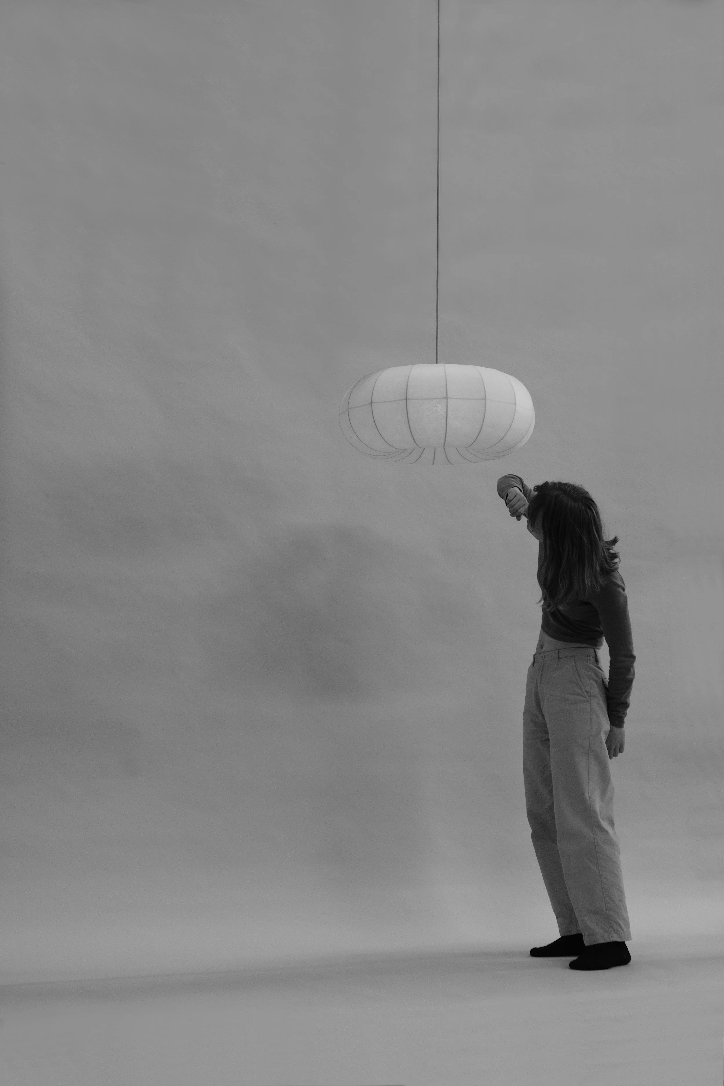 Plumus Pendant Light by Claud Christian – a sculptural paper pendant with curvaceous convex and concave curves, designed as a statement lighting feature for contemporary, minimalist, and design-led interiors. Featuring designer Claudia Surrage.