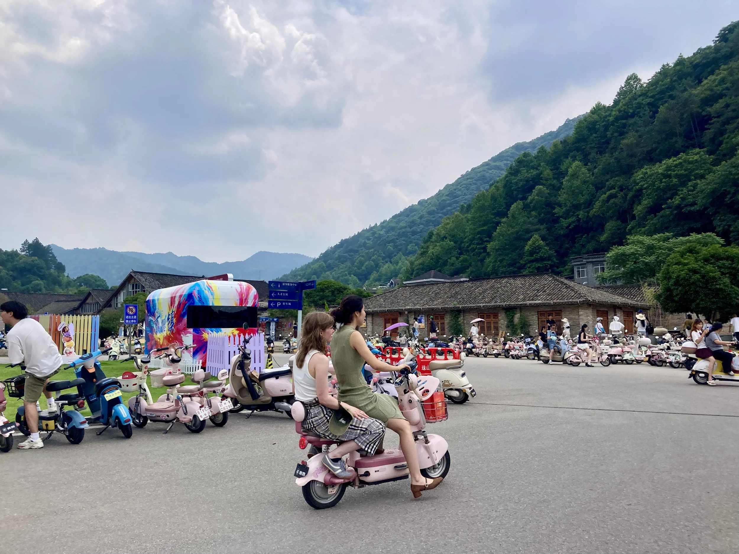 Claudia riding a moped in Sanbao, China
