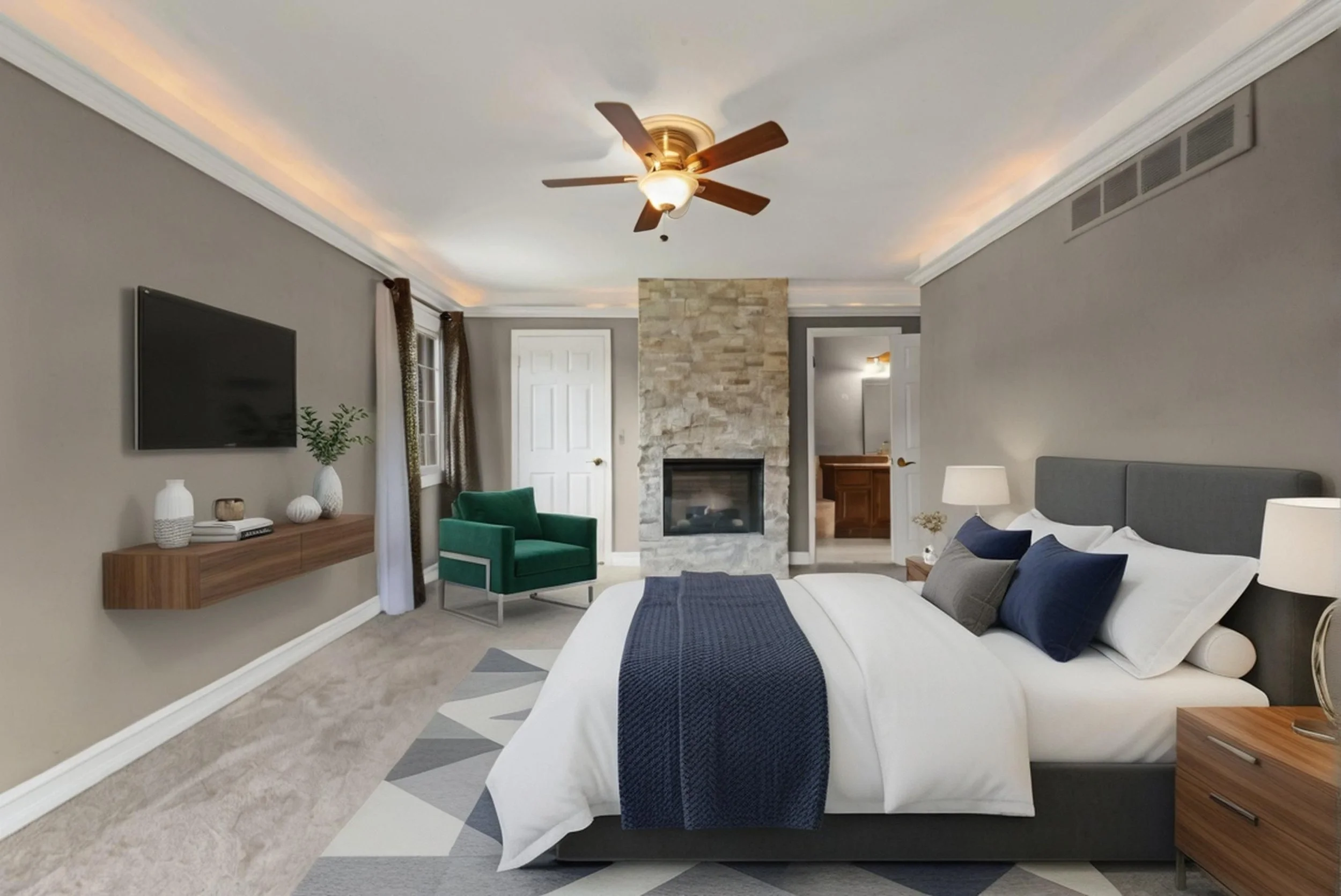 Living room with a white couch, blue pillows, a wooden side table, a green armchair, a stone fireplace, wall-mounted TV, ceiling fan, and modern decor.