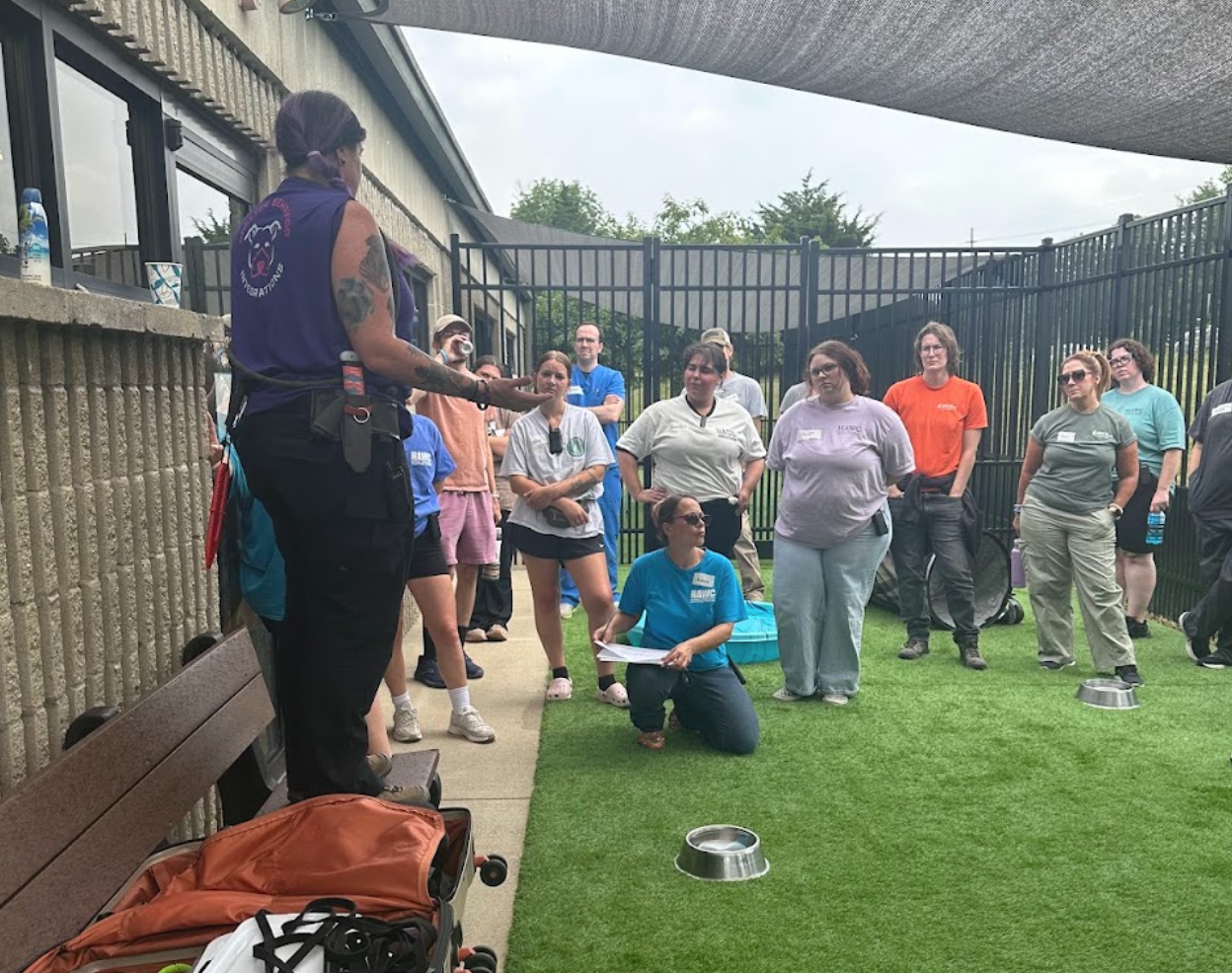 Laurie stands in front of a group of shelter staff and volunteers giving a training.