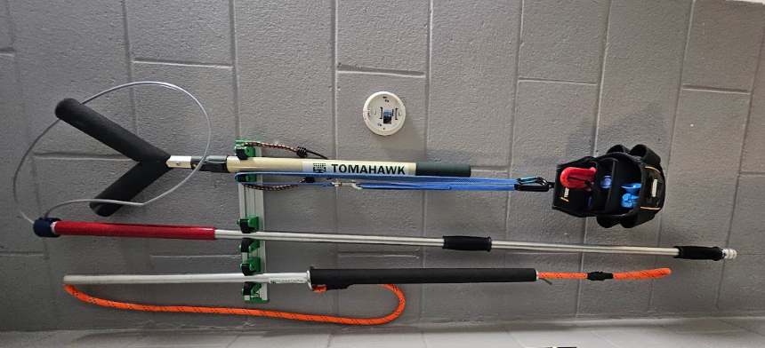 Animal restraint tools hang on a wall.