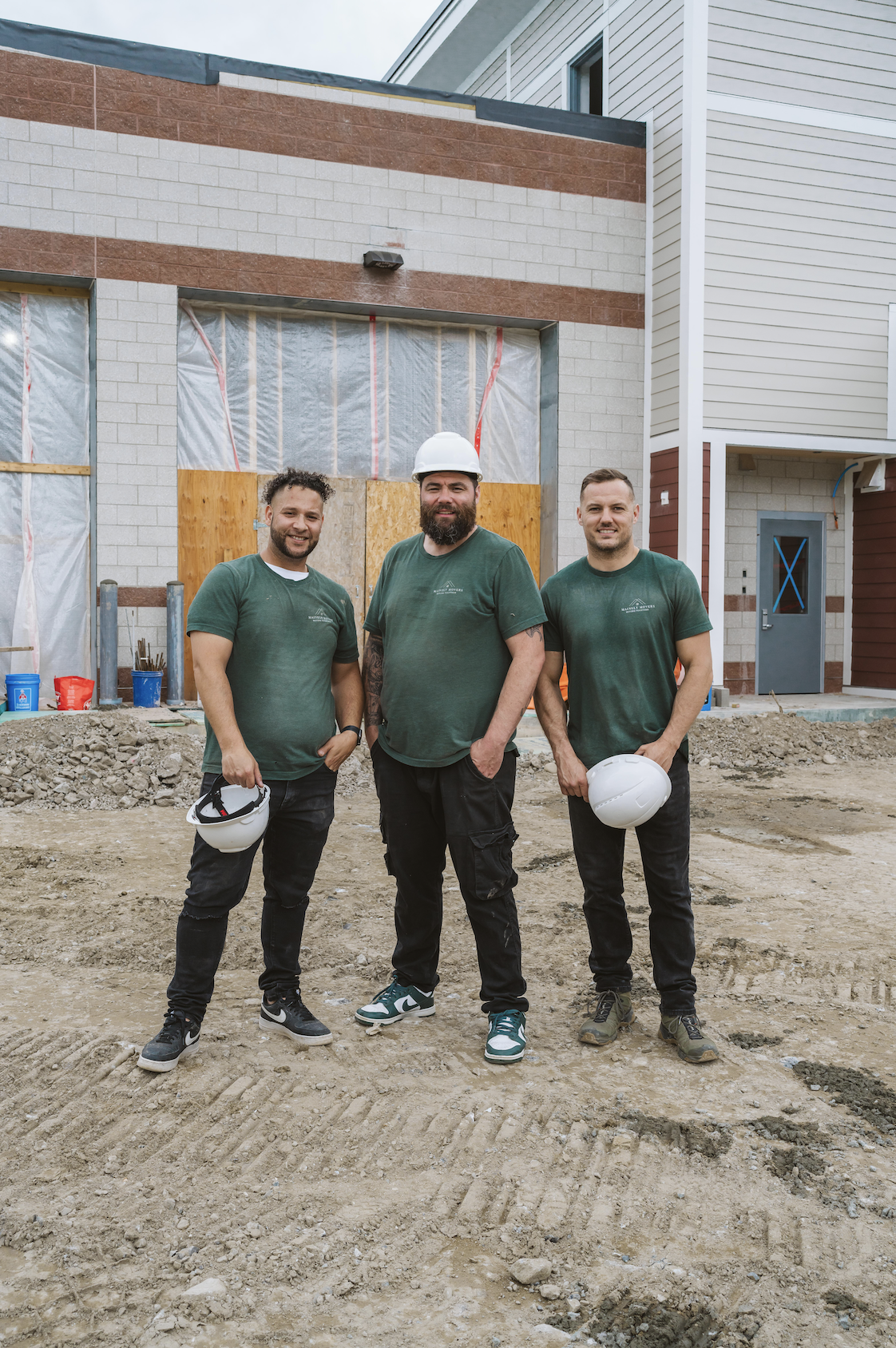 Moving company team of three movers finishing a job at a commercial client site.