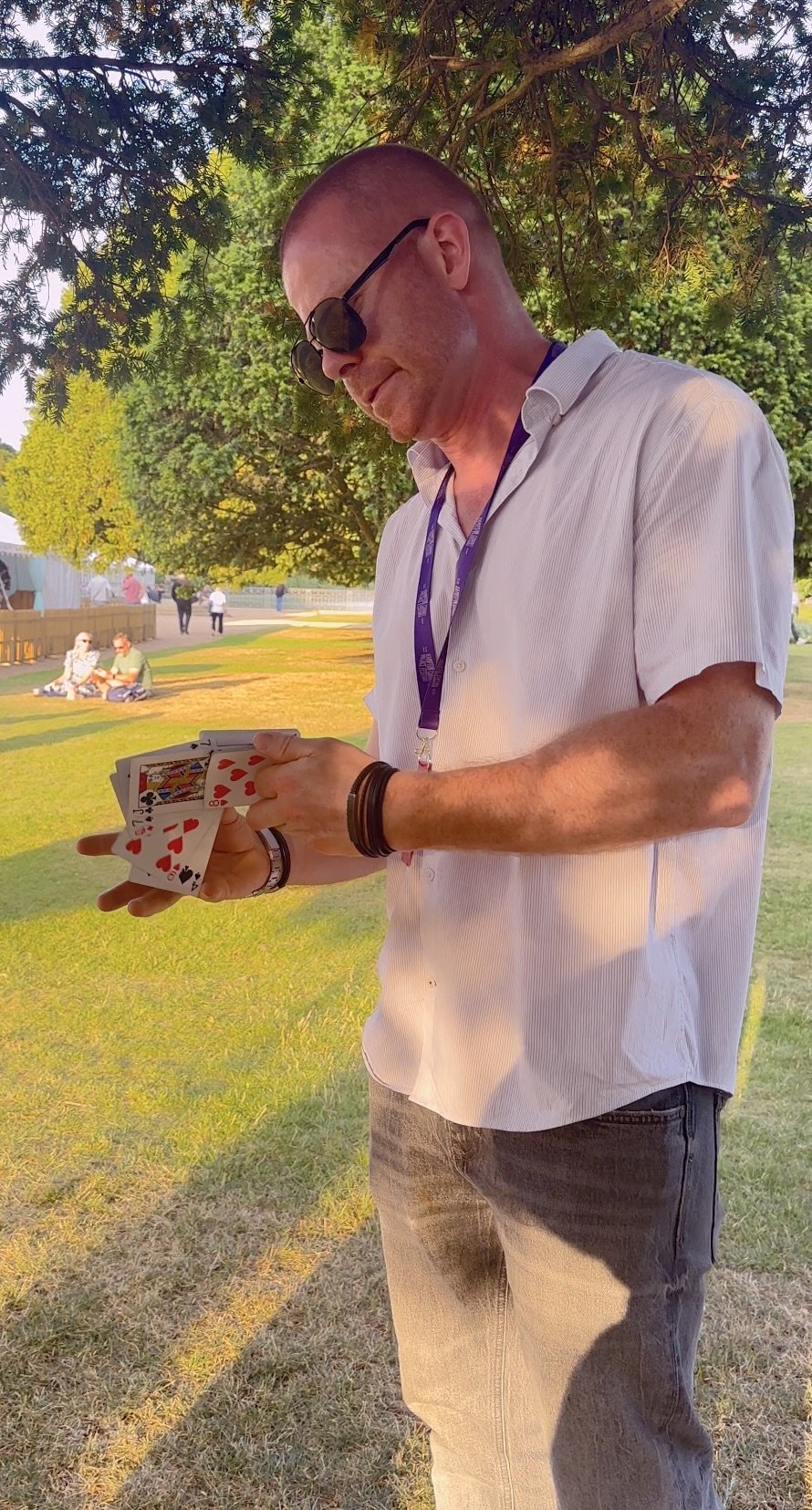 Close-up magician performing at festival.