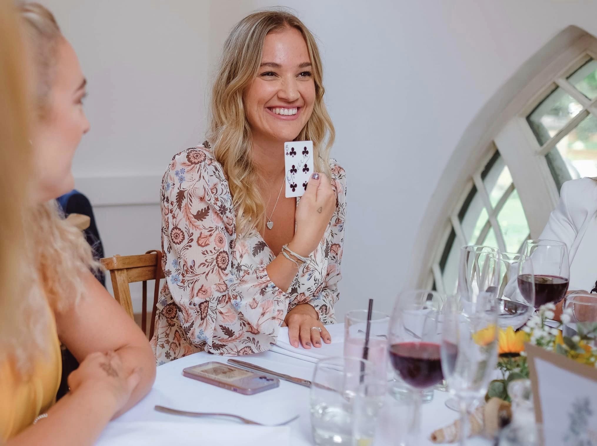 Wedding magician performing at table.
