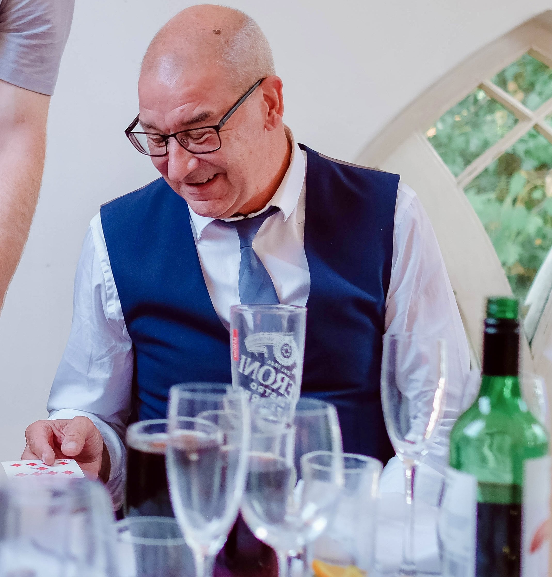 Close-up magician with wedding guests.