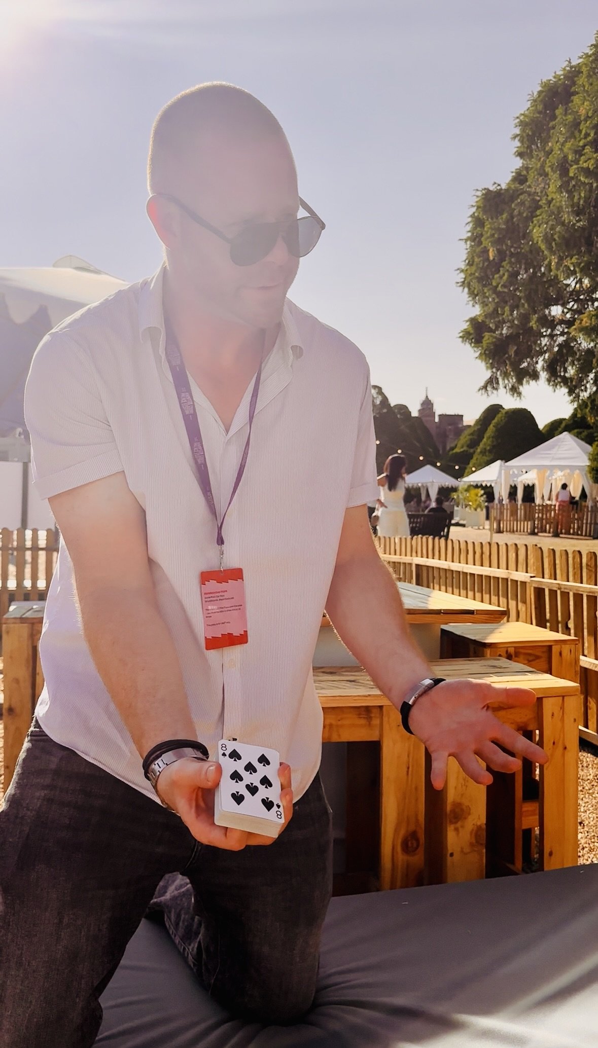 Close-up magician performing at festival.