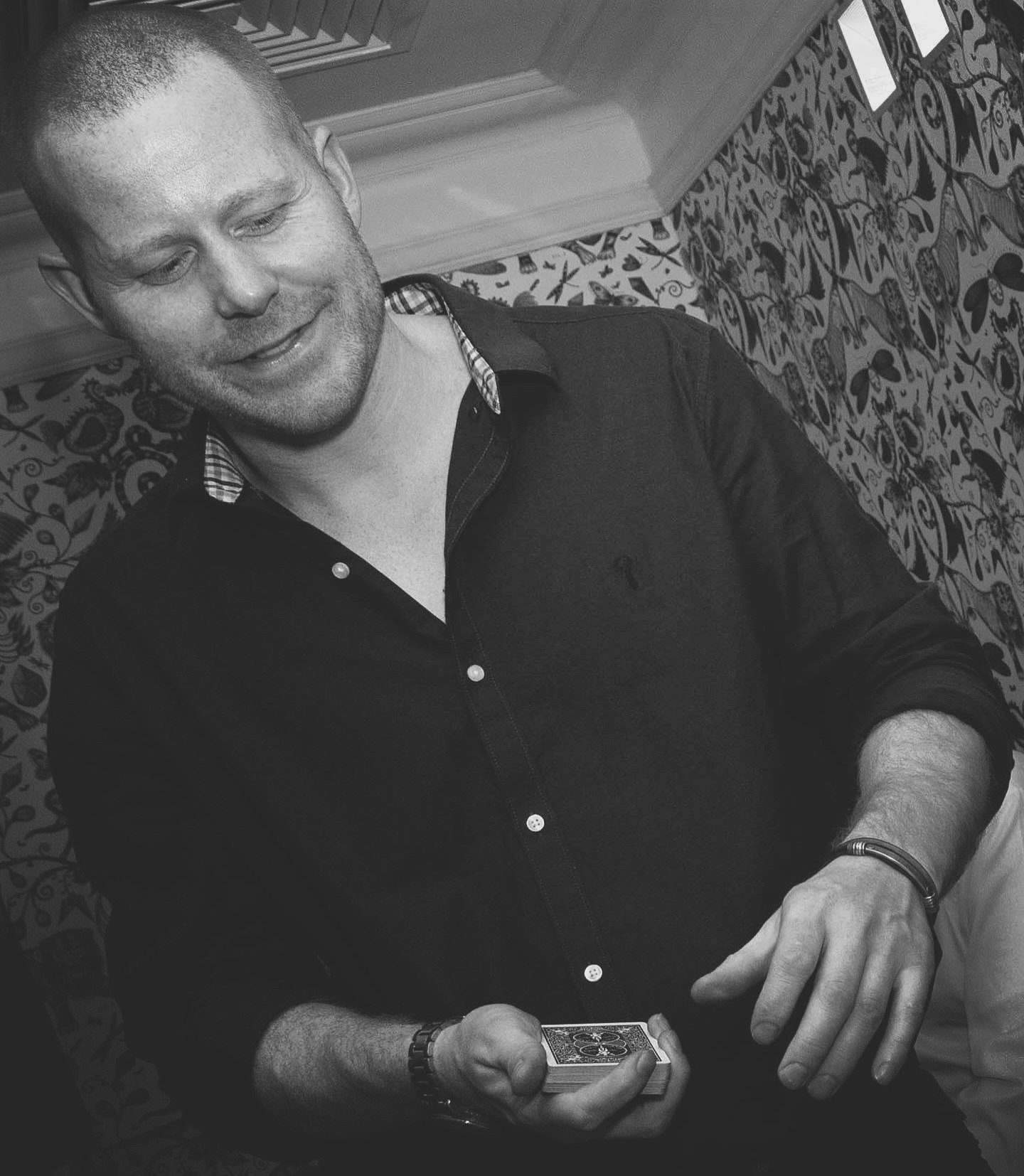 Magician with cards at event.