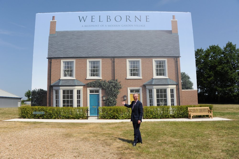 Secretary of State Rt Hon Michael Gove with a CGI showing one of Welborne's new homes