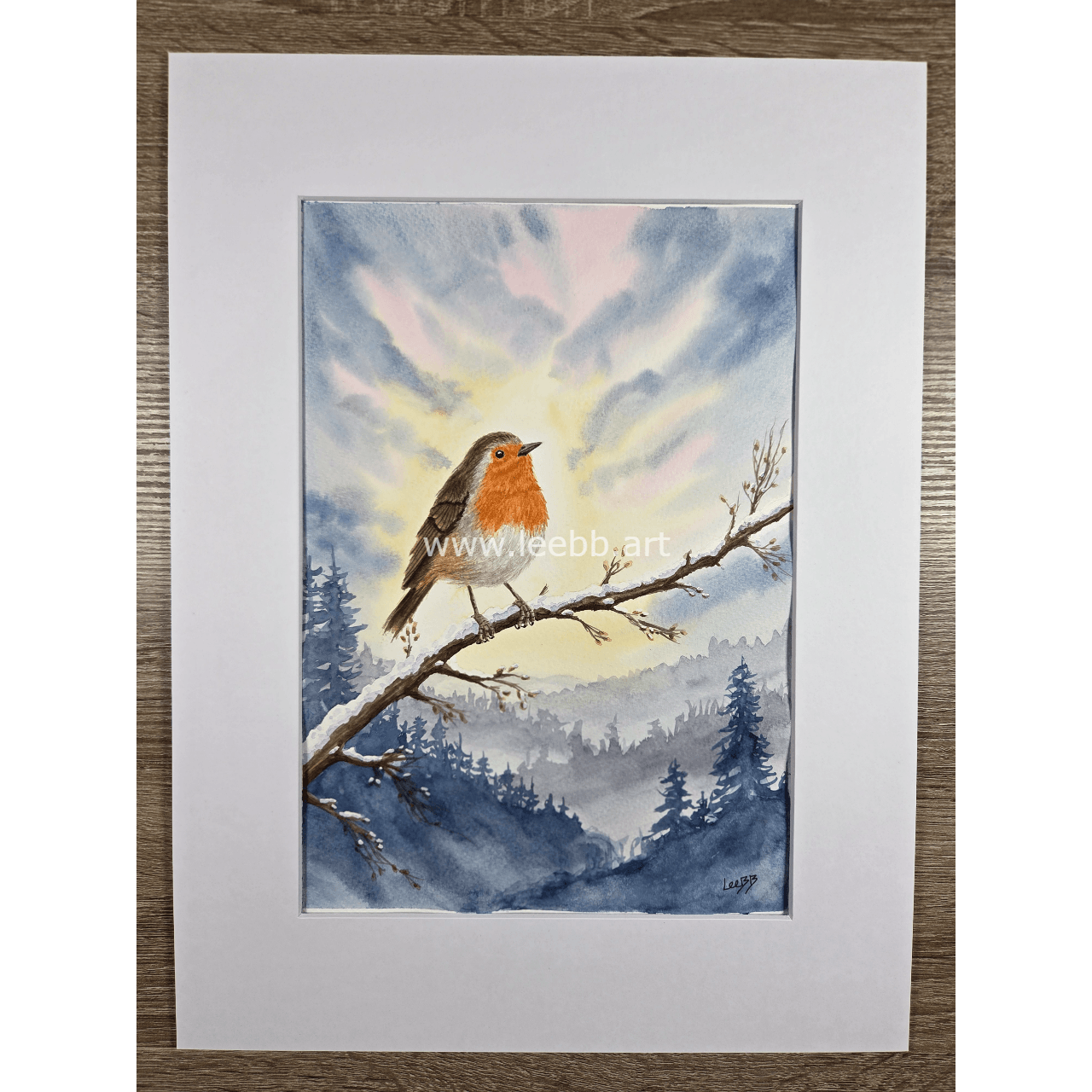 Original watercolour painting Winter Awakening featuring a robin surrounded by a crisp winter landscape
