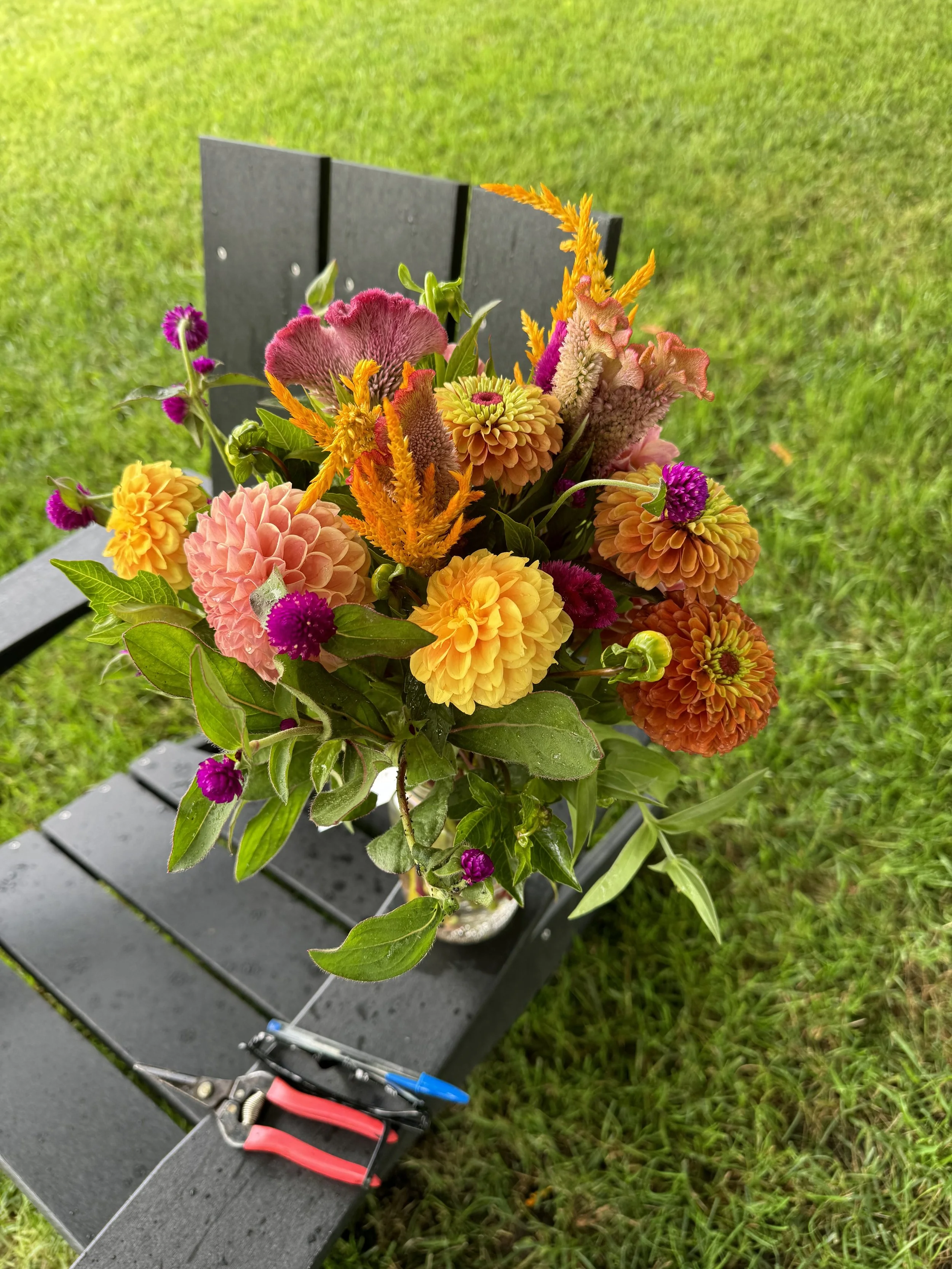 A fall-inspired flower bouquet in a glass mason jar at Muddy Acres.