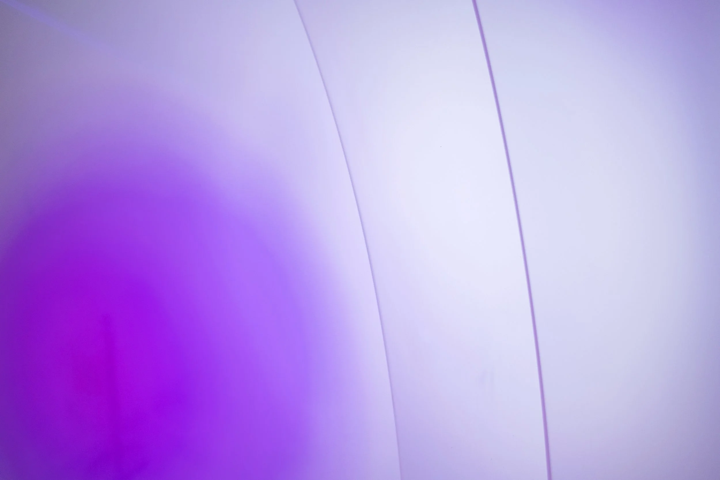 Abstract background with gradient shades of purple and white, and thin purple lines.