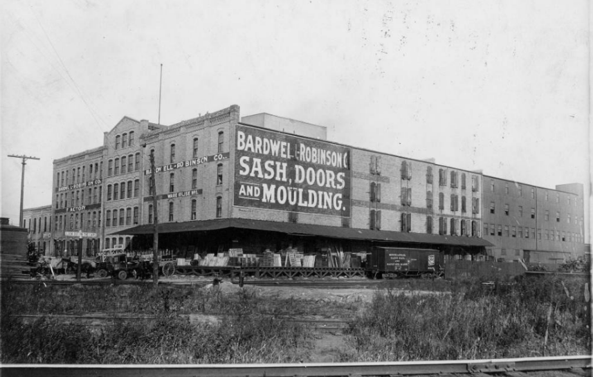 Black-and-white historic photo of Northwind Lofts when it housed Bardwell‑Robinson Sash, Doors & Moulding Co., showcasing the original 1885 industrial warehouse building in Northeast Minneapolis Warehouse District.