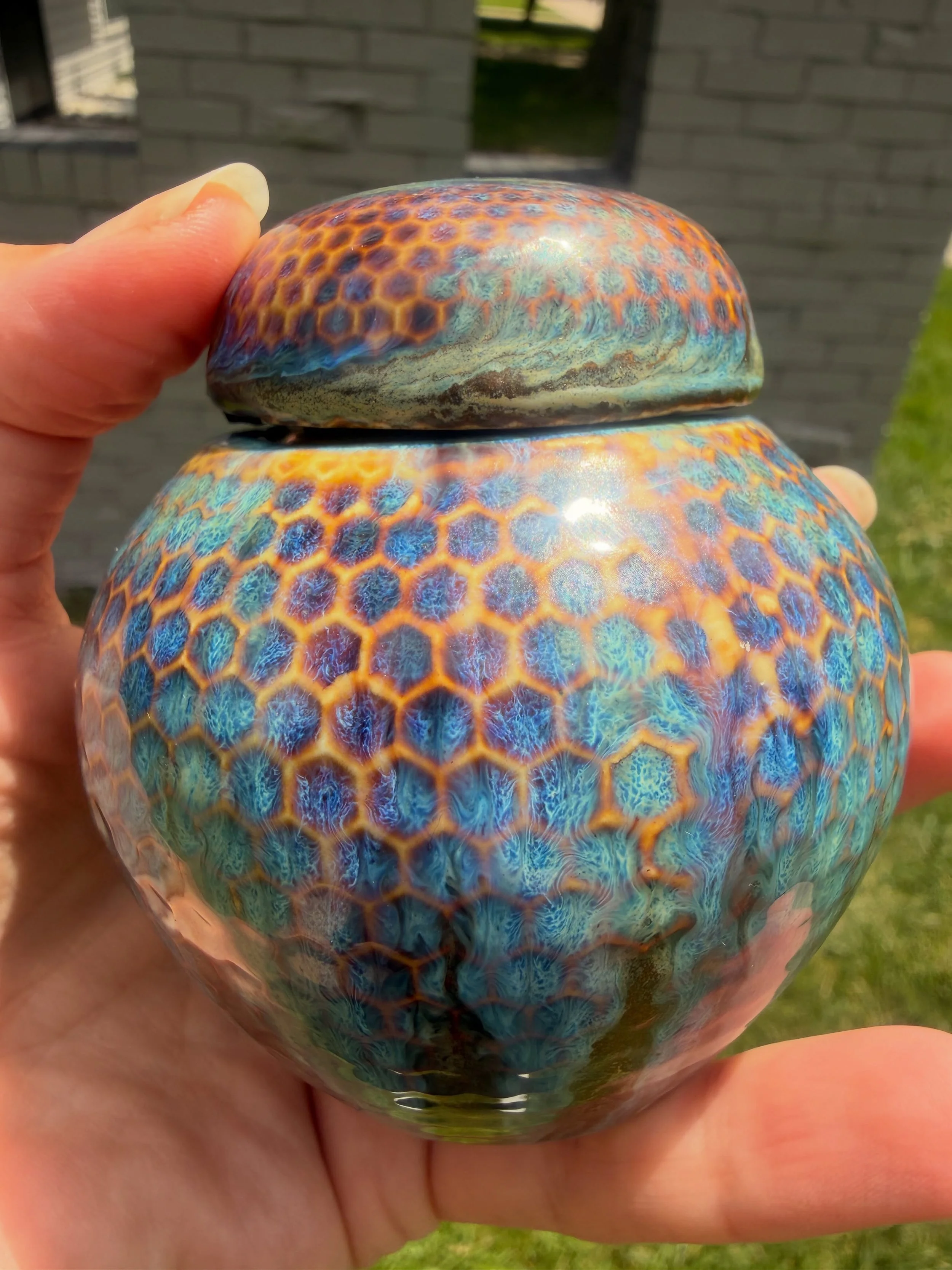 A custom urn finished and I am absolutely obsessed with how this glaze turned out. ✨

The honeycomb texture came alive in the firing with layers of deep blue, turquoise, and warm gold shifting across the surface in the most beautiful way. No two angl