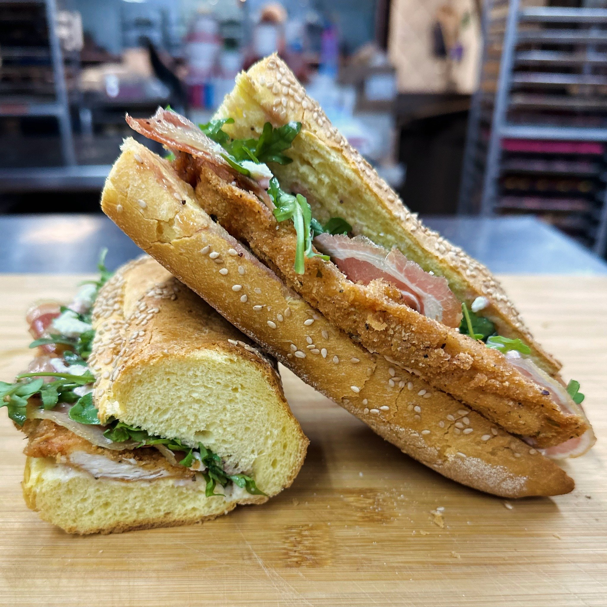 🚨SANDWICH SATURDAY🚨
Available Saturday, May 11th ONLY!
✨ The Mother Clucker Sandwich ✨

An artisanal semolina or brioche baguette, raspberry aioli, fried chicken cutlets, crisped pancetta, arugula, thinly sliced pears, crumbled feta, and finished w