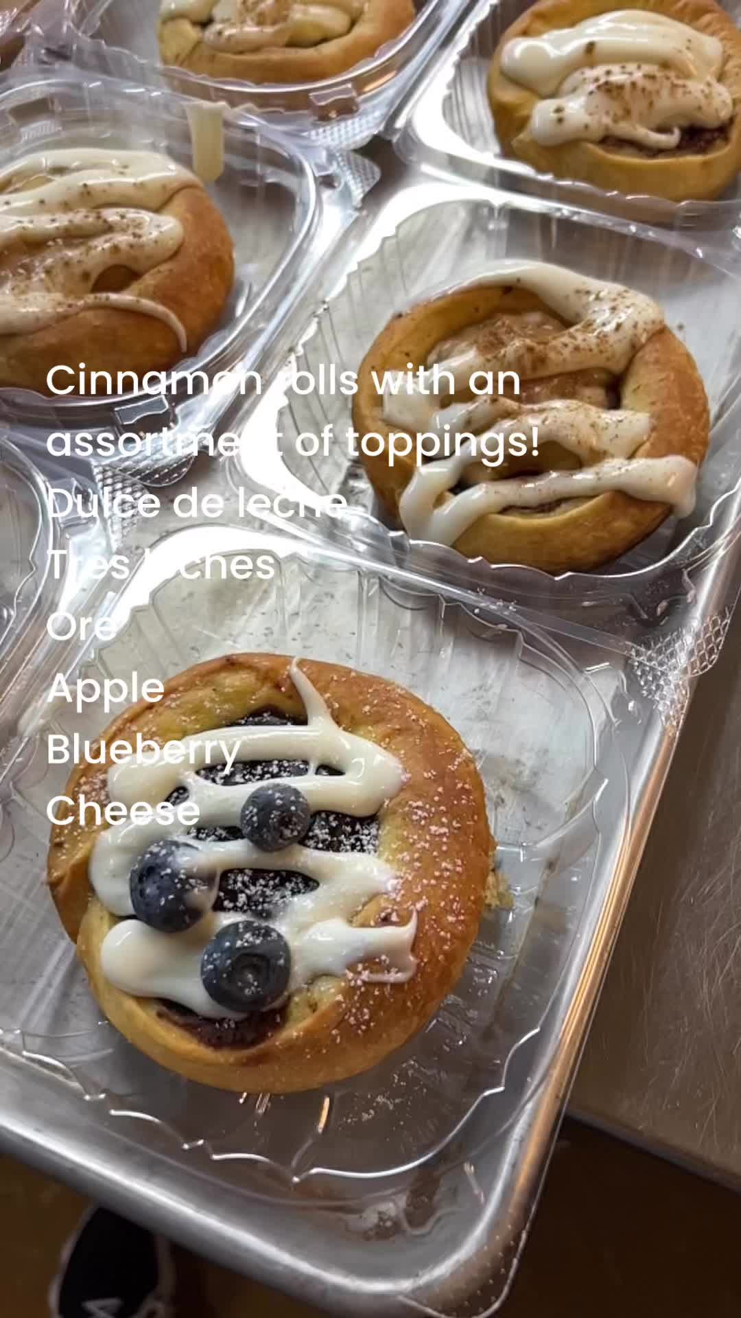 These cinnamon rolls are a delightful twist on the classic, each topped with a unique flavor: Tres Leches for a moist, milky sweetness; Oreo with crushed cookies and cream frosting; Apple featuring warm spiced apple compote; Blueberry with tangy-swee