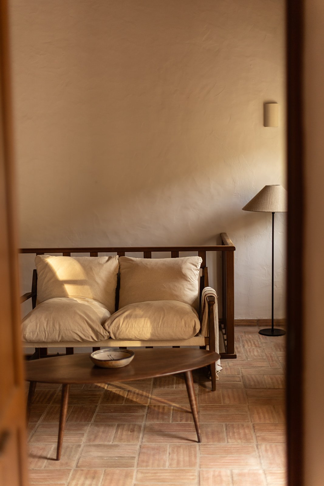 Inviting communal seating area at Casa de Cura, a peaceful Algarve mountain retreat in Portugal, offering a cosy space to relax, unwind and connect with like-minded women between yoga practices.