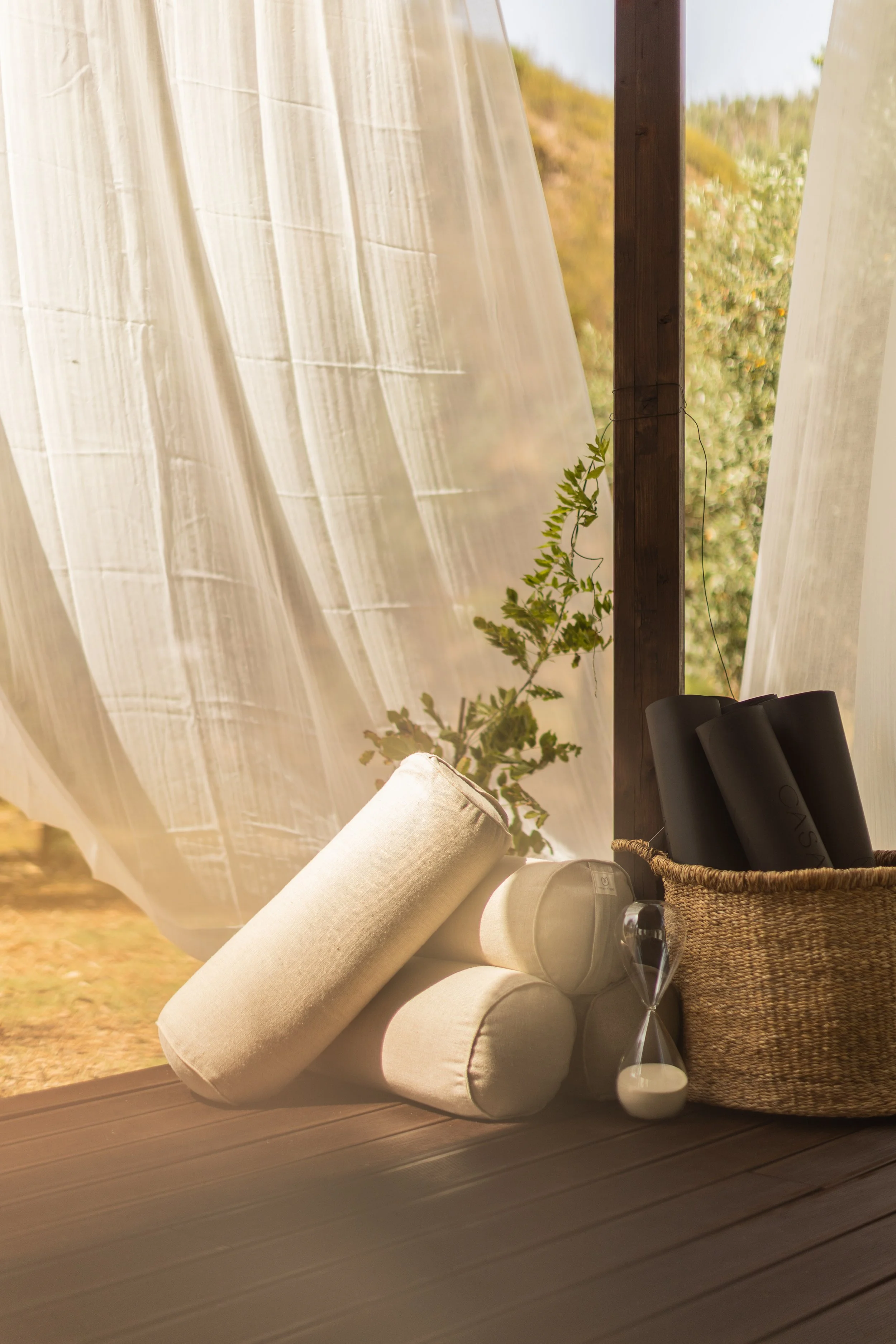 Yoga mat, bolster and props arranged in the peaceful shala at a Portugal yoga retreat, ready for a restorative yoga and meditation practice.