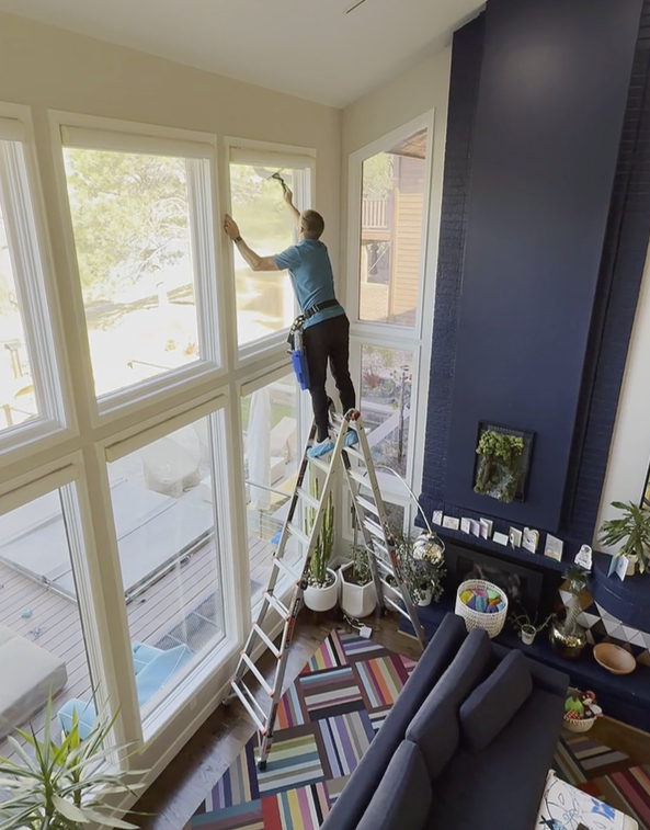 Clearview Cleanings Professional squeegeeing interior living-room window tracks for a crystal-clear shine and brighter natural light