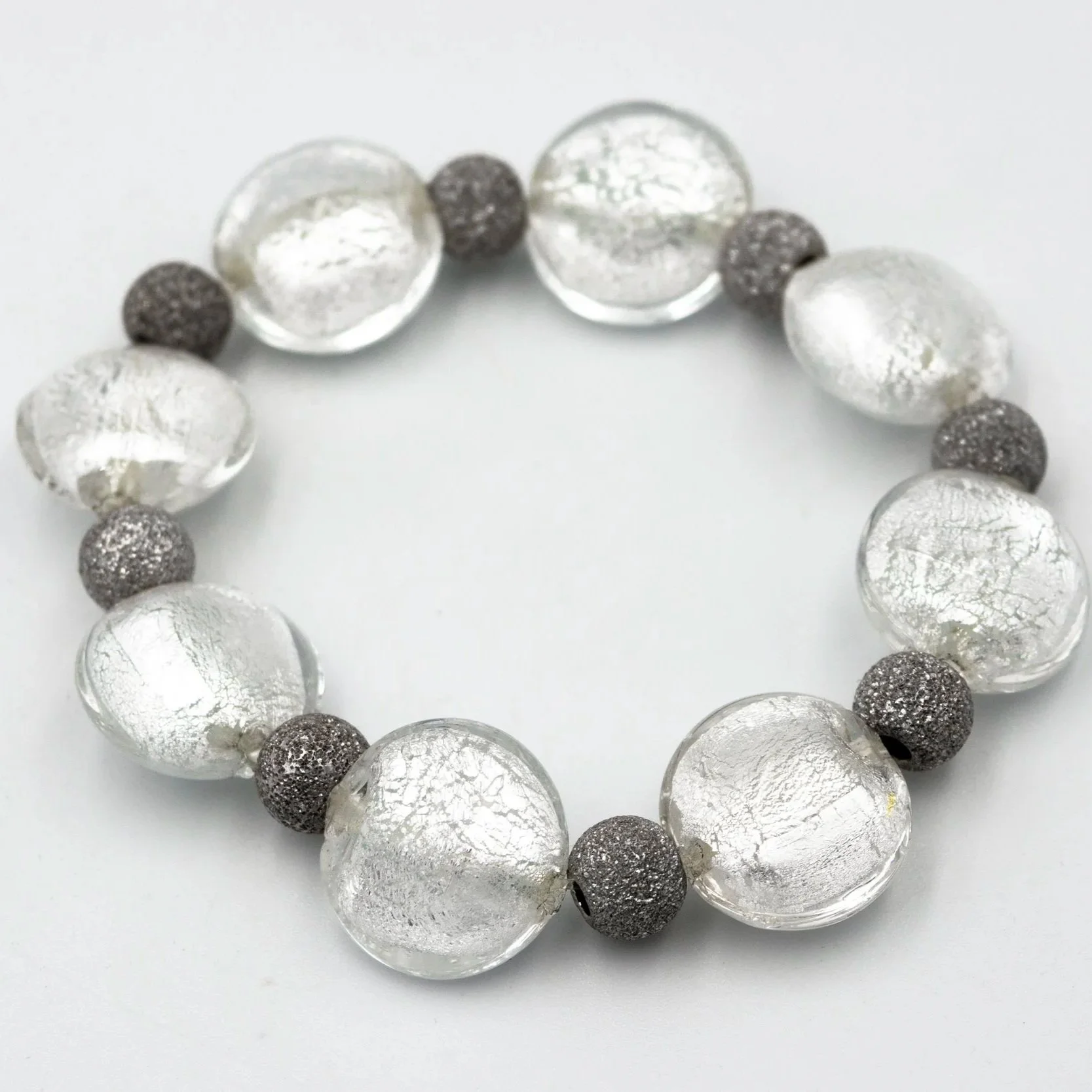 Detalle de pulsera Argento hecha a mano en vidrio de Murano con reflejos plateados y plata de ley.