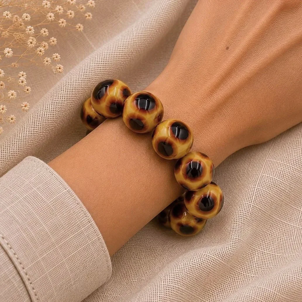 Mujer llevando pulsera Sáhara de vidrio de Murano artesanal y plata de ley con reflejos cálidos y naturales.