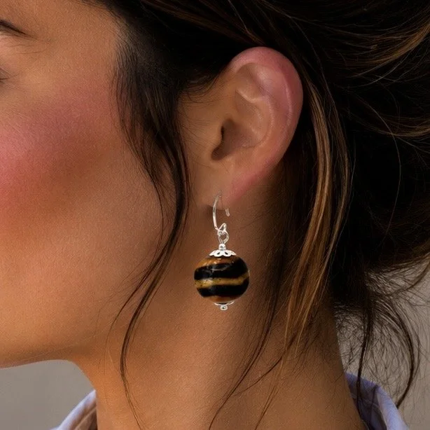 Mujer llevando pendientes Ayla de vidrio de Murano artesanal y plata de ley con diseño femenino y elegante.