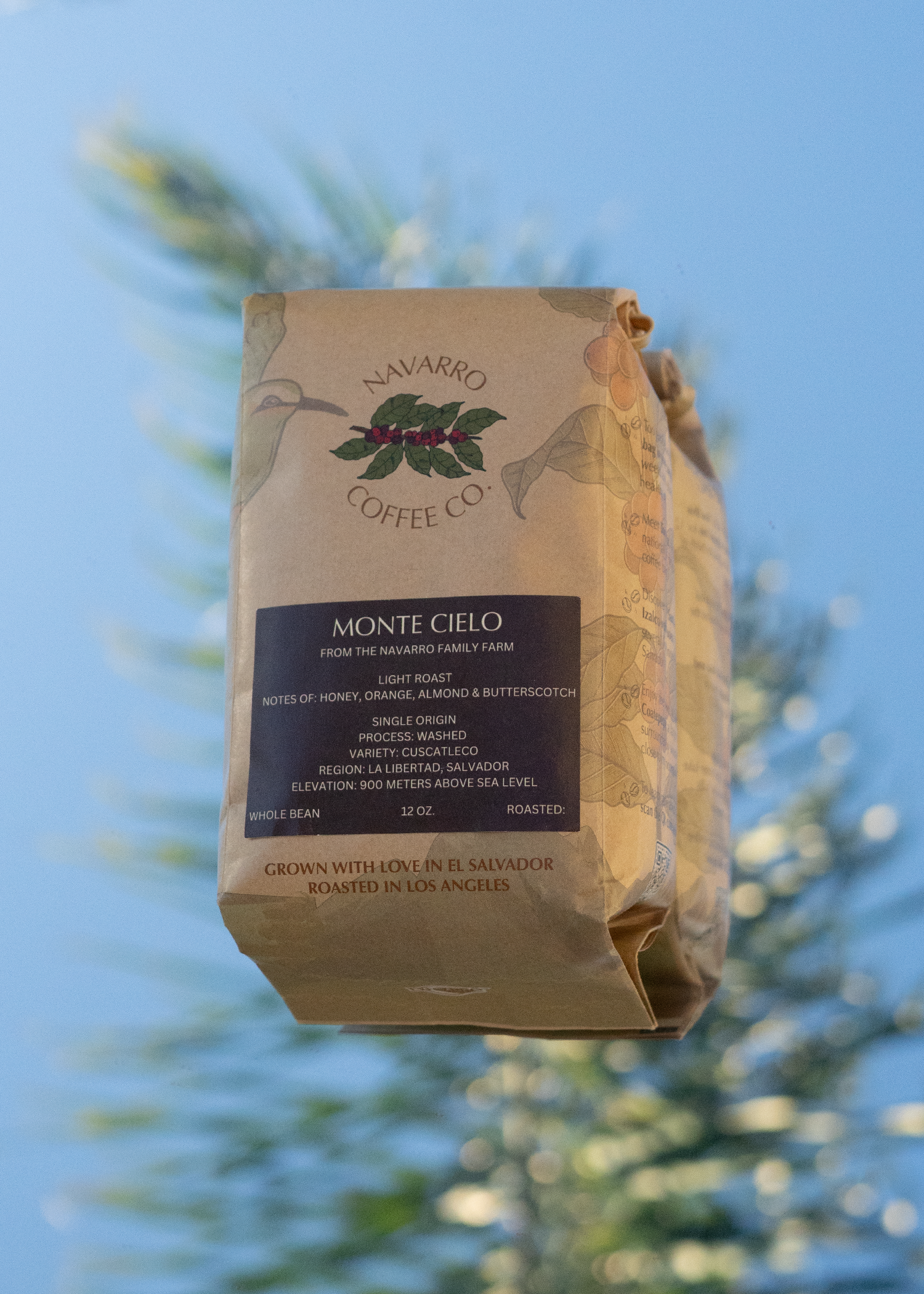 The Monte Cielo Coffee bag is on a mirror with a reflection of the sky in the background