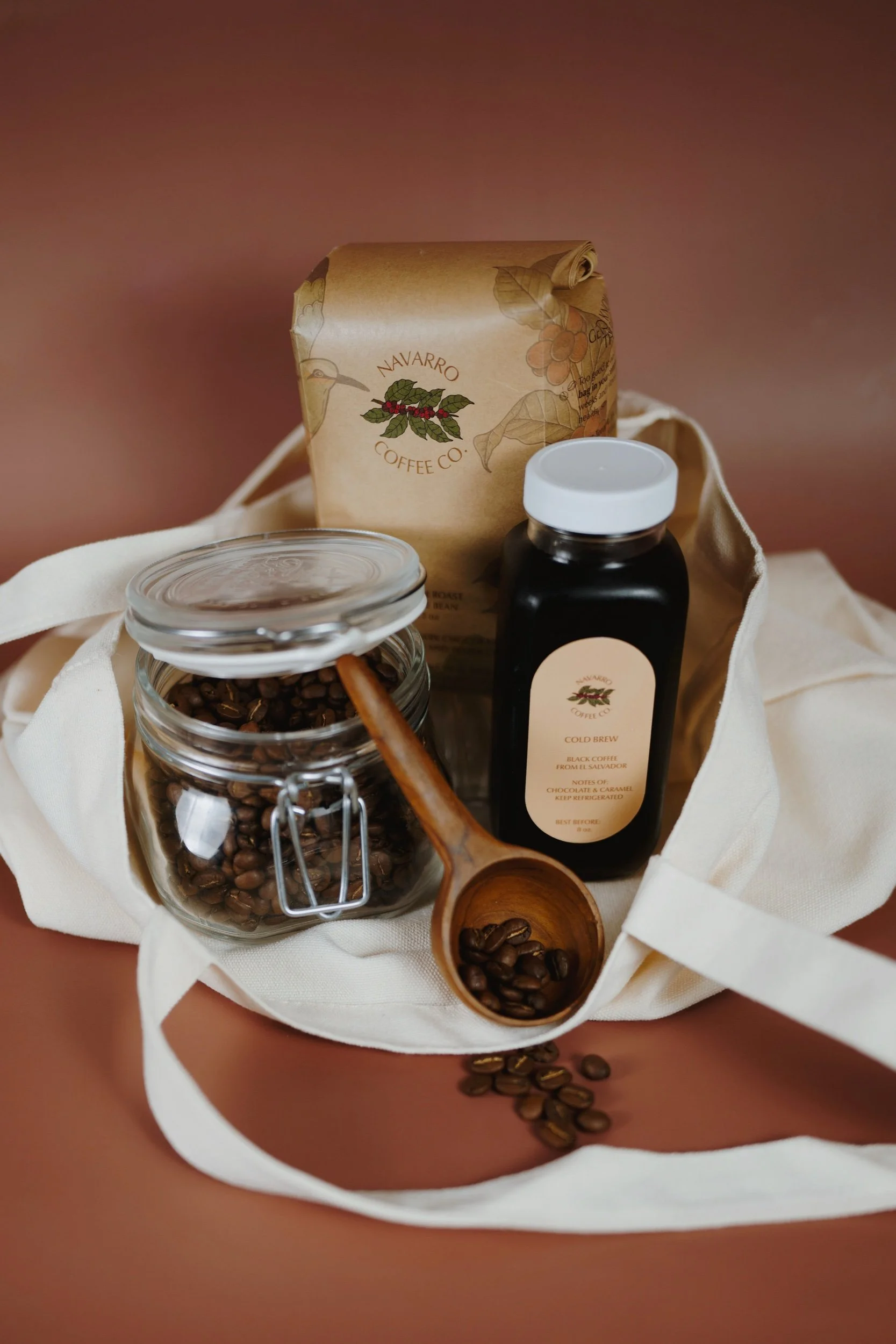 Navarro Coffee Co El Salvador whole bean coffee bag, bottled cold brew, organic tote bag.