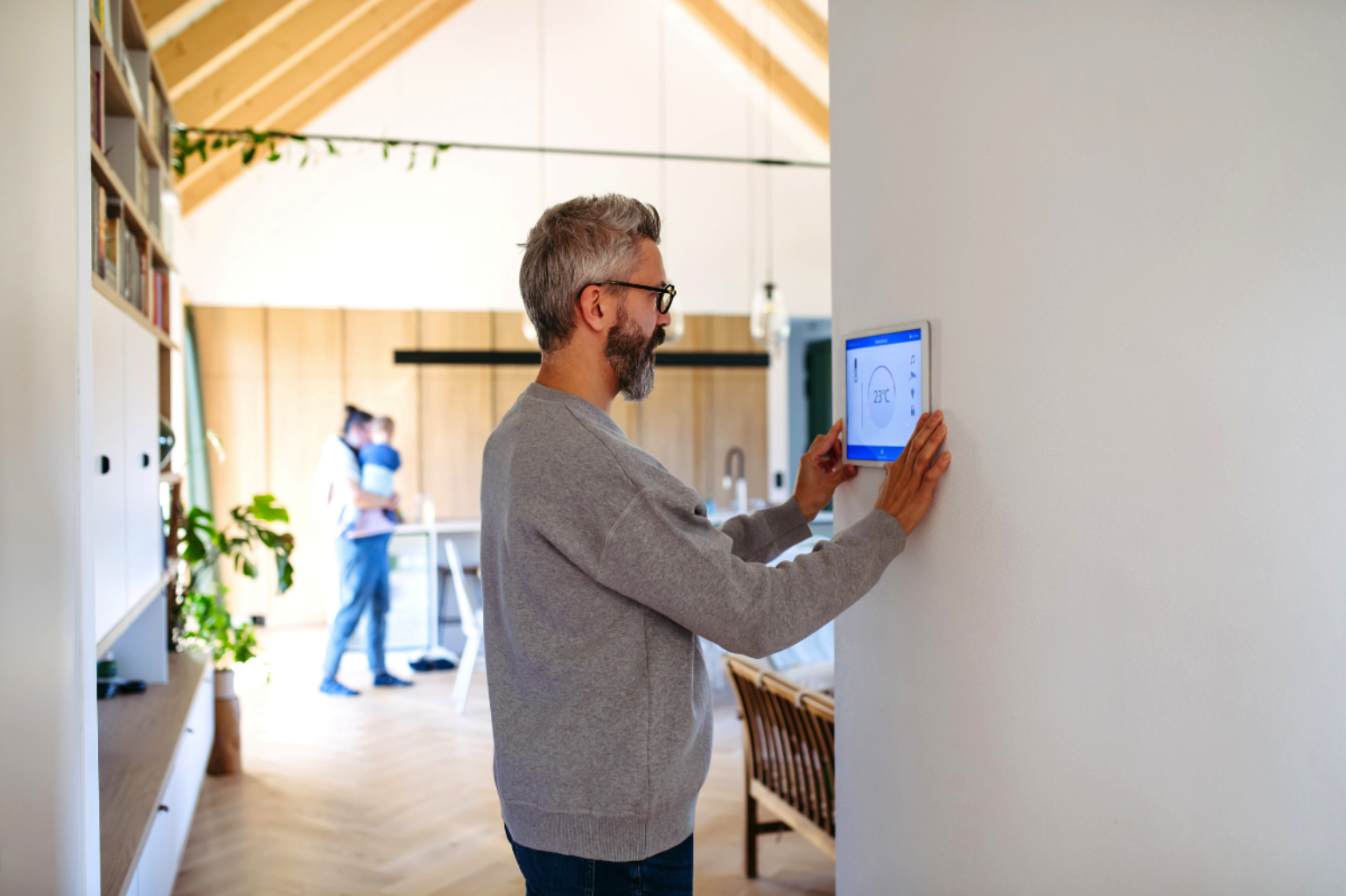 man adjusting home temperature
