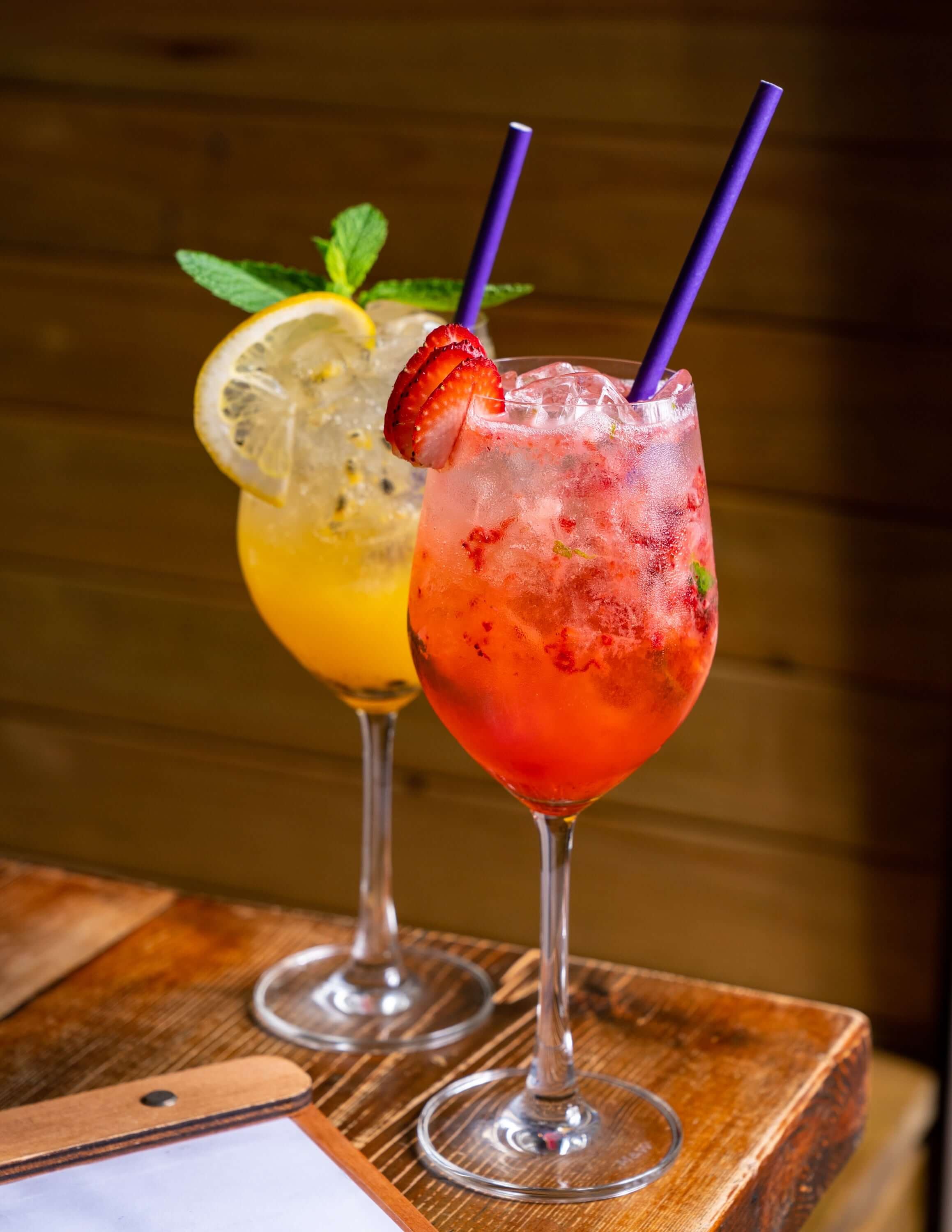  two bright cocktails with lemon and strawberry 