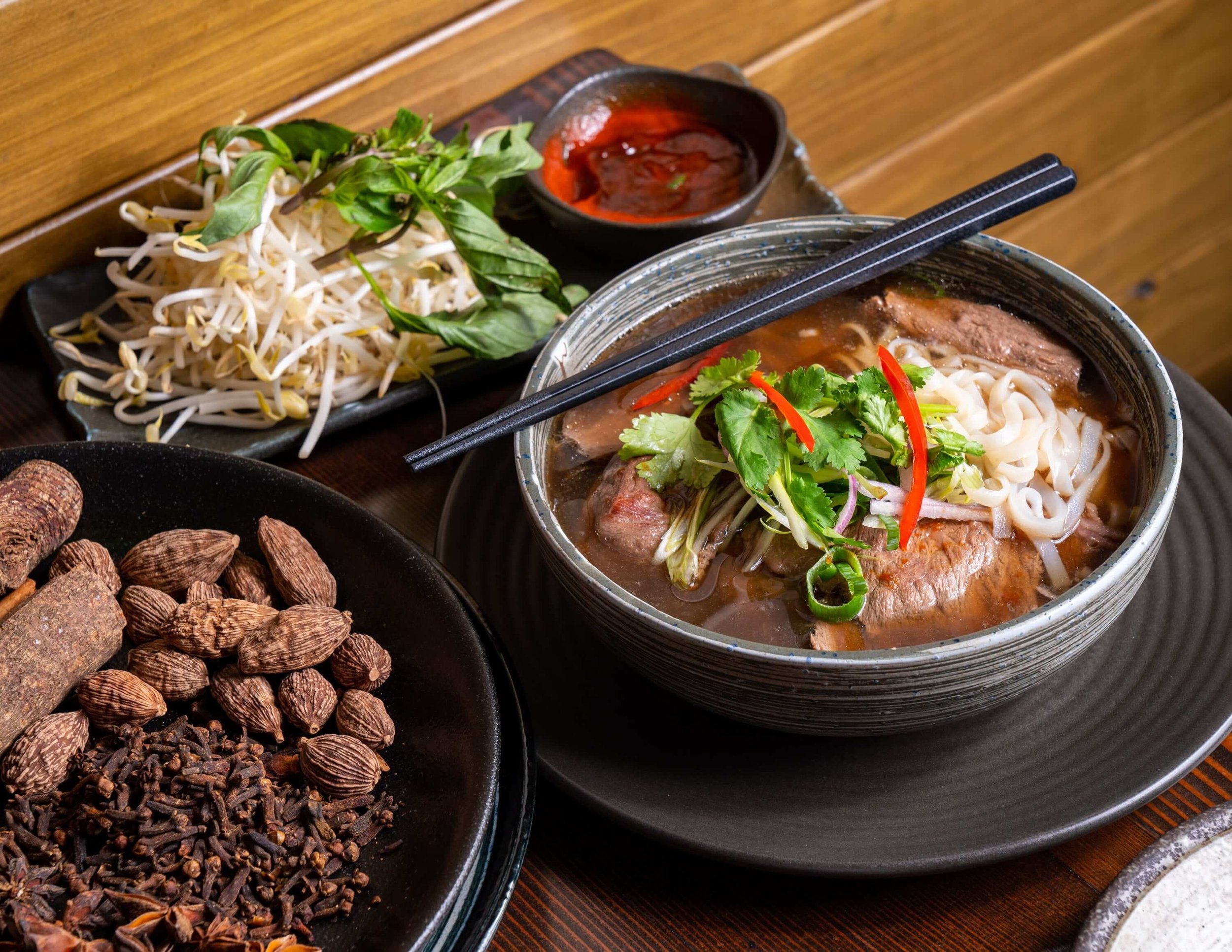  a beef soup with glass noodles and sides 